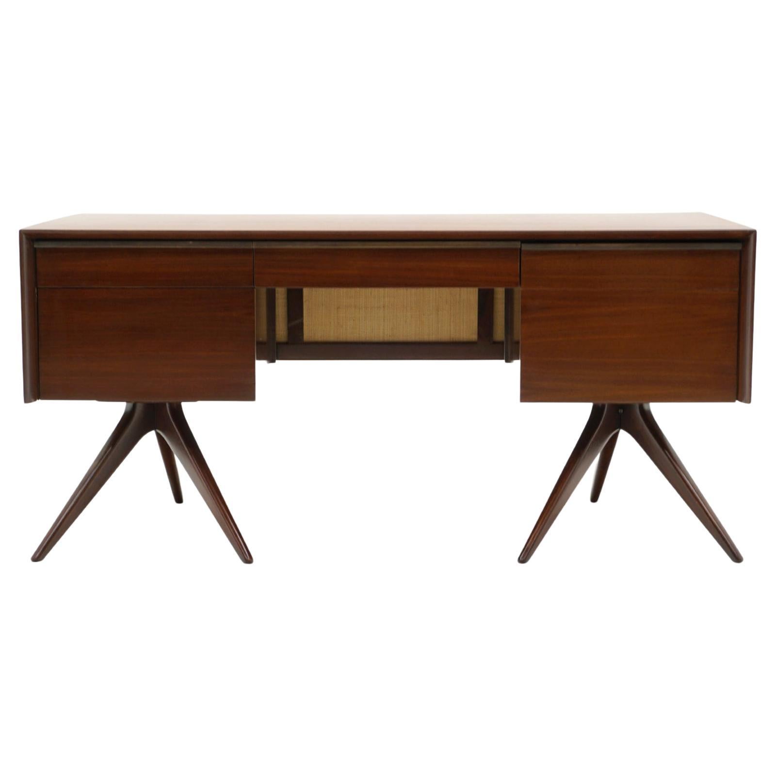 Early, one of a kind, Vladimir Kagan Desk.  Walnut case with cane modesty panel.  Super cool and sleek design.  Classic Kagan sculptural tripod legs support each side.  We believe the desk was refinished in the recent past as it is in very good