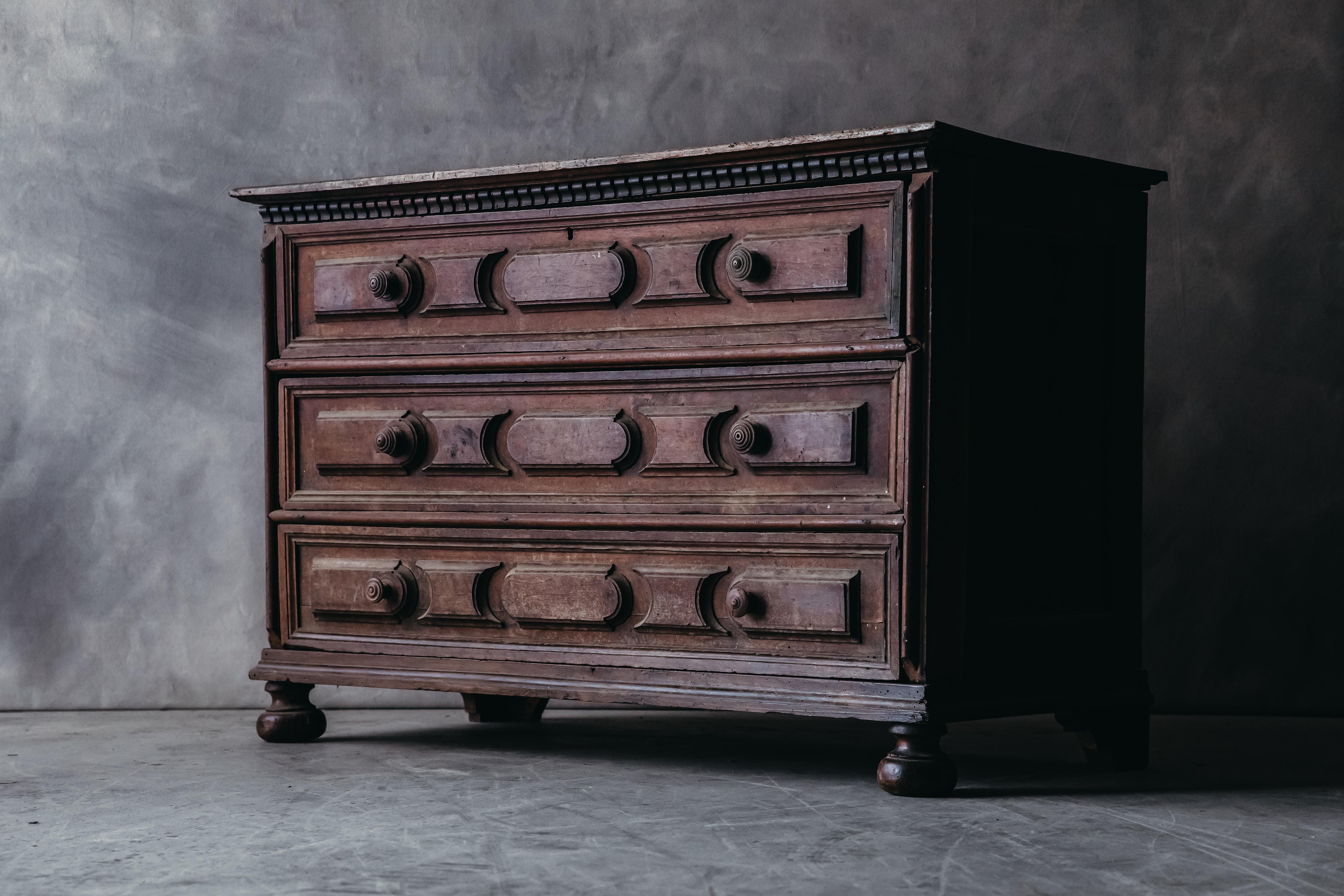 Early Walnut Chest Of Drawers From Italy, circa 1800. Solid walnut construction with hand turned handles and detail. Amazing patina.