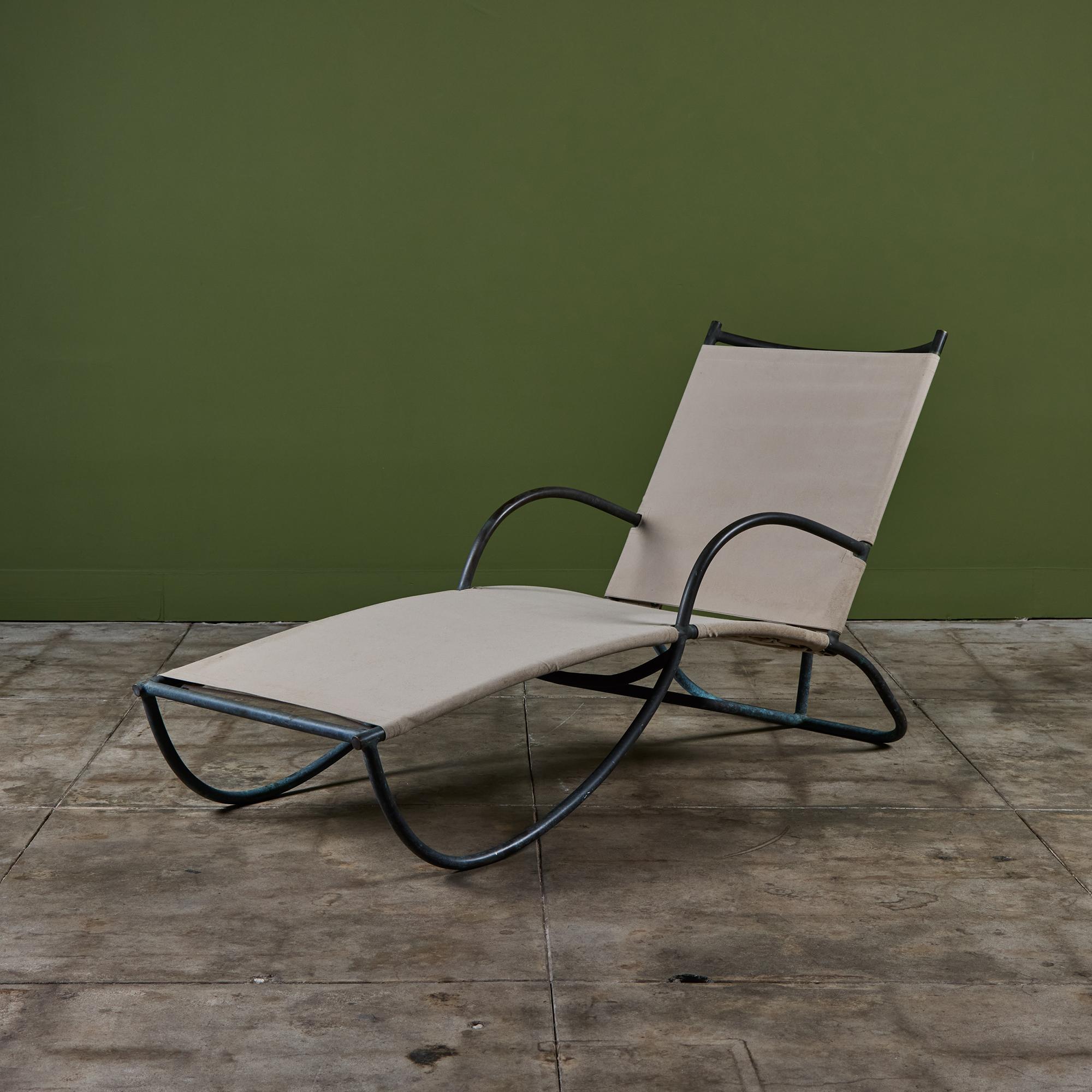 The late 1940s or early 1950s early S-Lounge patio chair by Walter Lamb predating his partnership with Brown Jordan. The chaise lounge is rendered in thick bronze tubing with a canvas sling seat laced tightly to the frame with sailcord. Its namesake