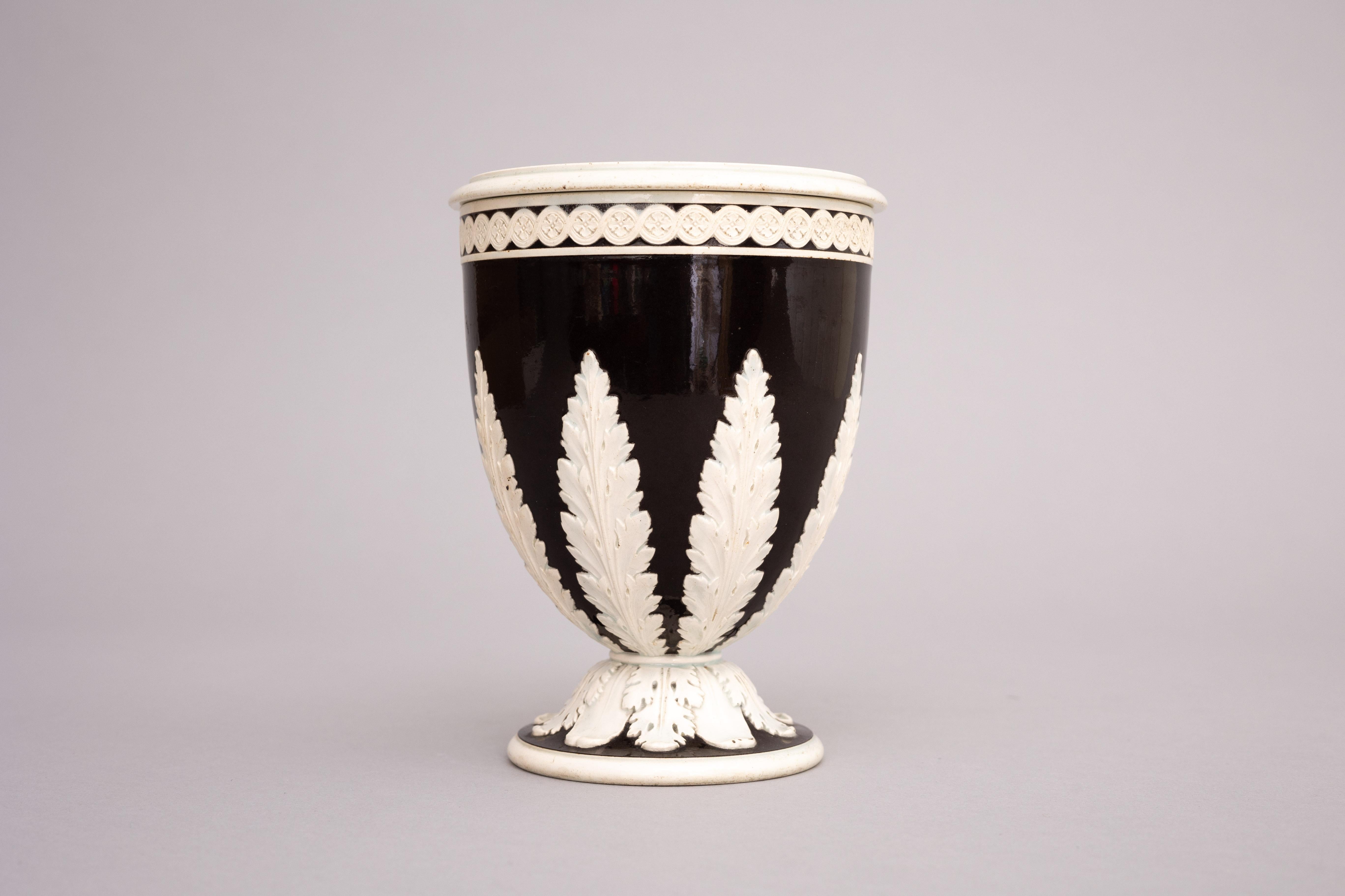 A dark brown pearlware bough pot with pierced cover and acanthus leaf decoration, made by Wedgwood circa 1785.

Josiah Wedgwood developed his pearlware glaze in 1779 as a white-ware alternative to his wildly popular creamware, or ‘Queen’s ware.’