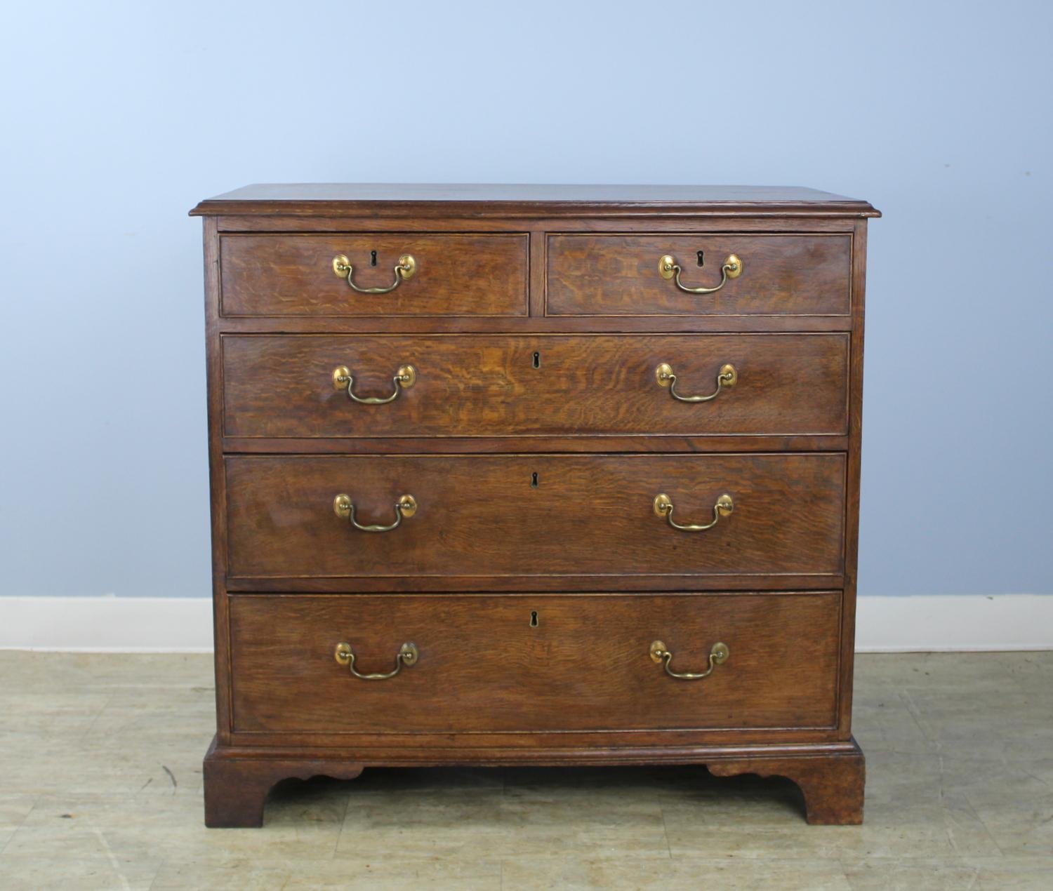 A lovely early Welsh chest in very good antique condition. Two over three, the bureau has a very good color and patina, with fine oak grain on the top. The ogee feet are original, as are the drawers' cockbeaded edges and brass hardware.