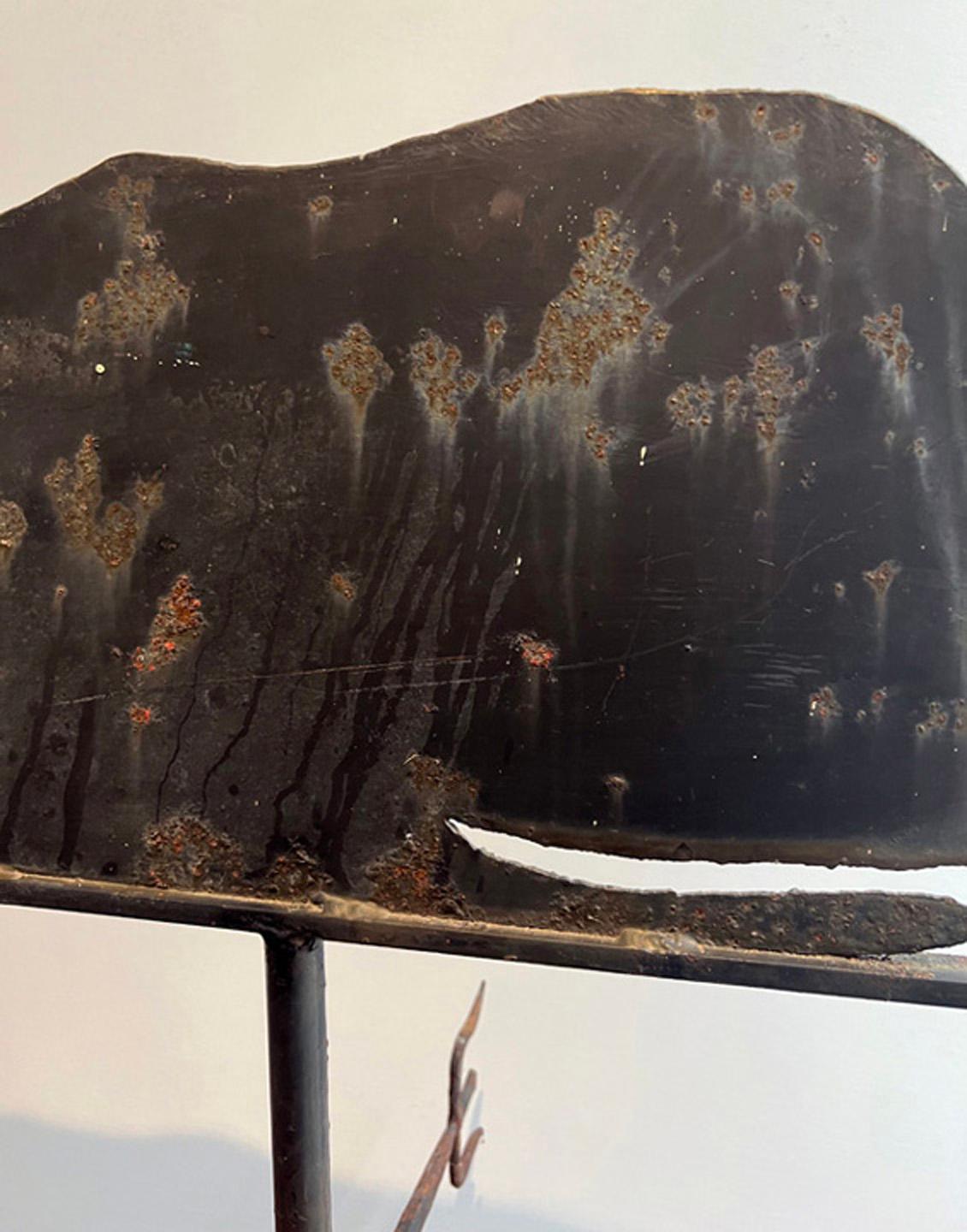 This is and example of an early American Antique weather vane Sperm whale. Hand made by a skilled black smith the details are amazing. The directions are accented by sharp pointed iron work. It has an amazing twist to the tail that wake it a really