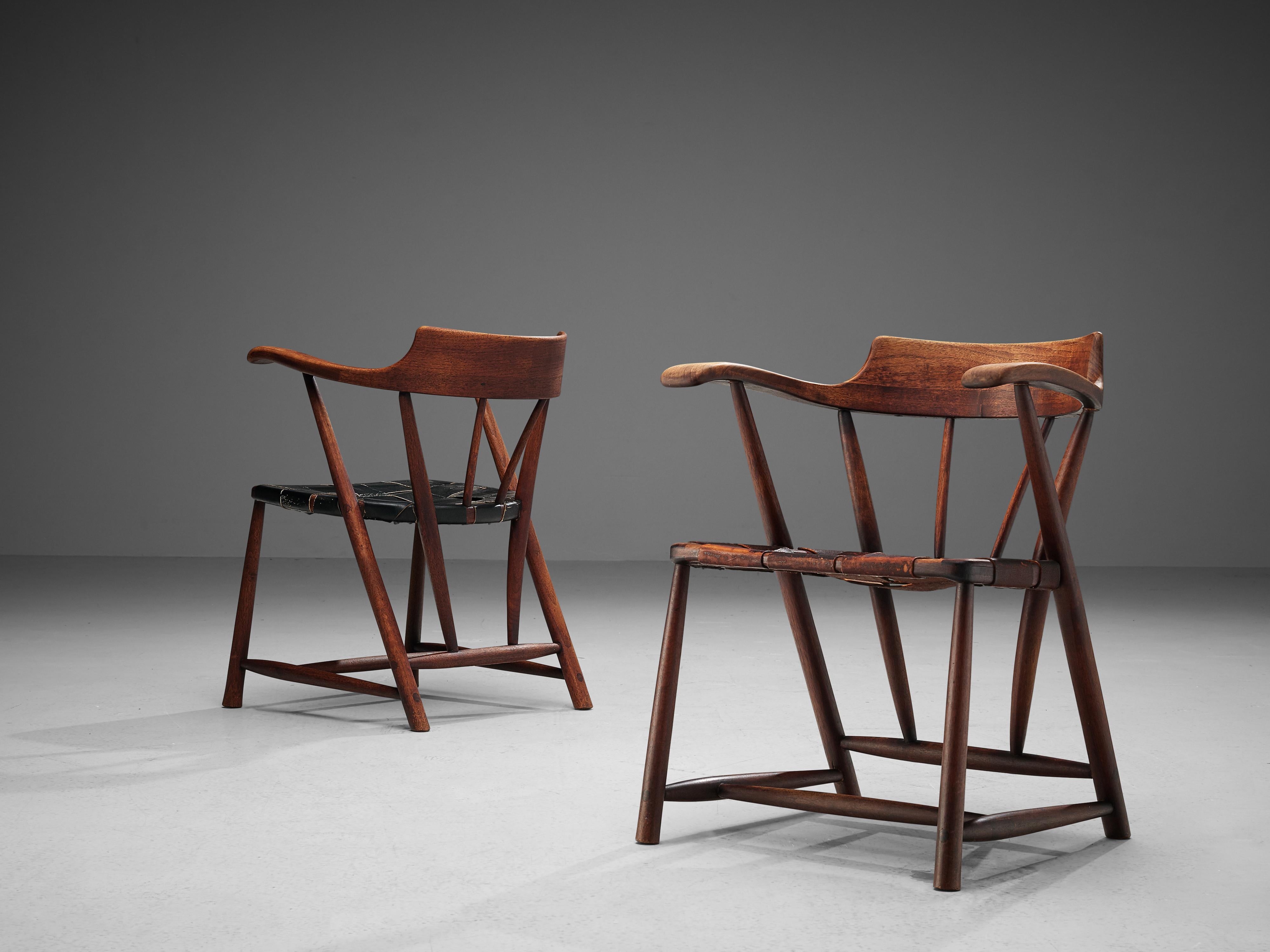 Wharton Esherick, ‘Captain’s Chairs’, American walnut, black/ brown leather, United States, 1951

This beautiful set of ‘Captain’s Chairs’ is a striking example of American designer Wharton Esherick’s oeuvre. The chairs both are one of the first