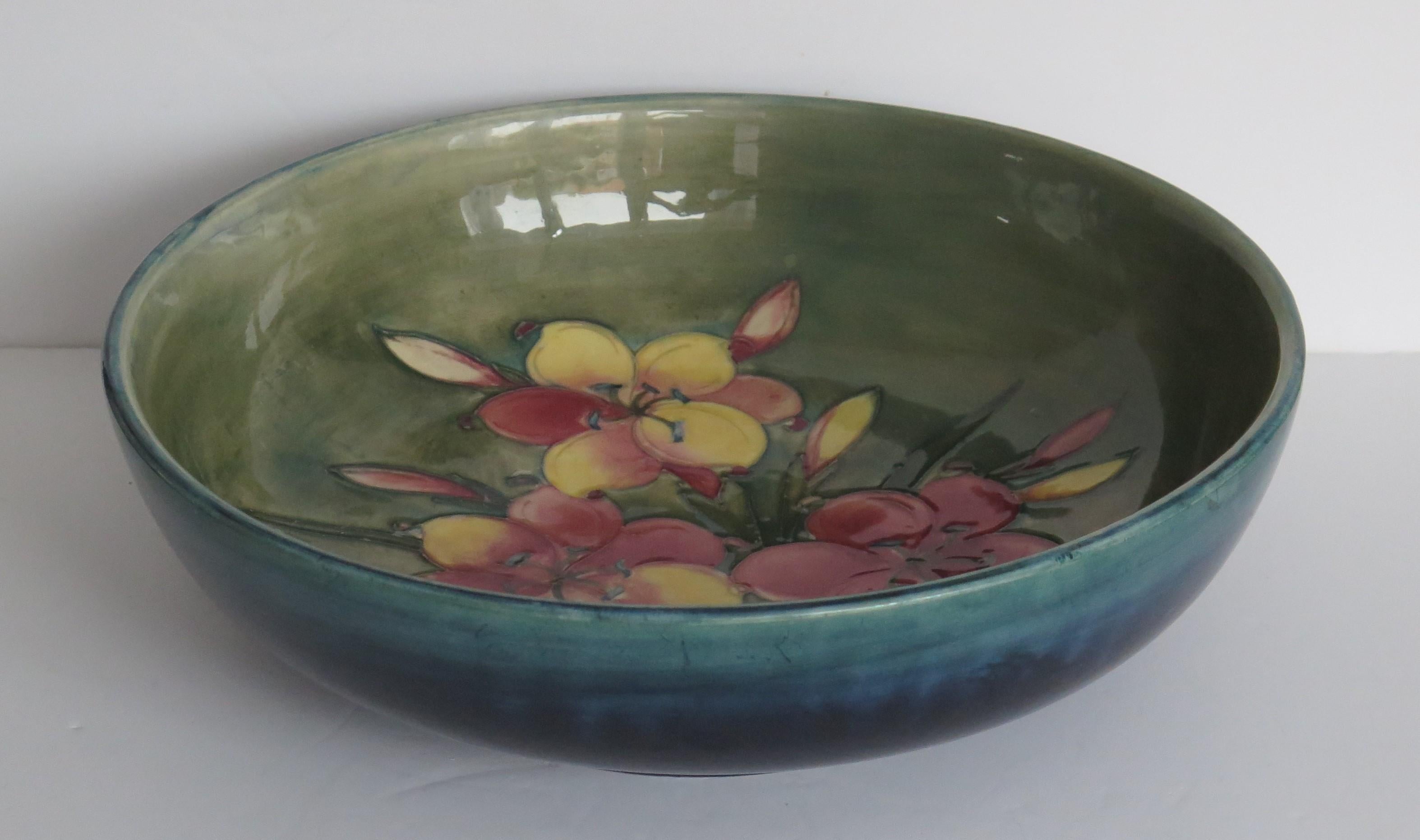 This is a very good early example of a large diameter bowl made by William Moorcroft, of Moorcroft Pottery in the Freesia pattern and dating to circa 1935.

A very beautiful large early Moorcroft Bowl in the usual distinctive bold colours.

The