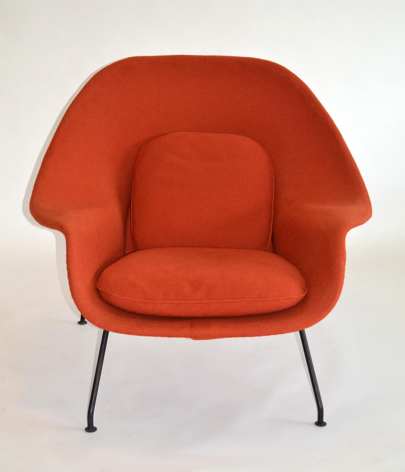 Early womb chair and ottoman by Eero Saarinen for Knoll c. 1952
This true vintage piece, a delightful iconic lounge chair and ottoman was re upholstered c. 1982 in a Knoll terracotta-colored fabric. Structurally sound shell and frame. Foam is hard