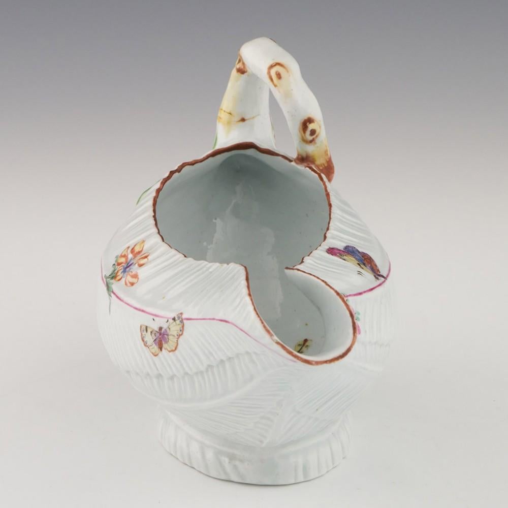 Heading :  Early Worcester porcelain sauce boat
Date : c1752
Period : George II
Origin : Worcester, England
Colour : Polychrome
Features:  Moulded cos lettuce leaf body with painted and moulded flowers and butterflies
Condition : Excellent, no chips