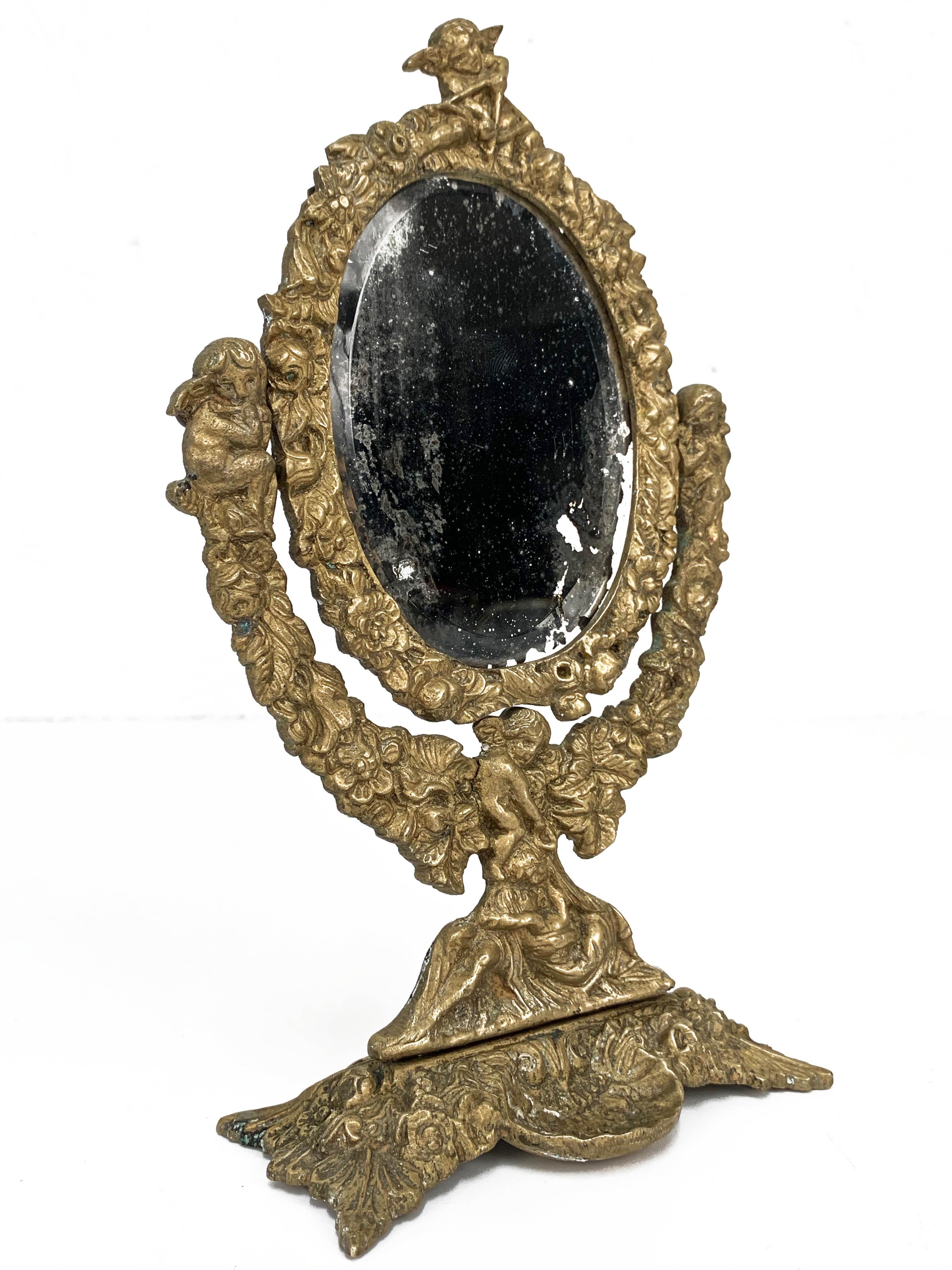 Amazing Italian Mercury gilded table mirror produced during the 20th century in Italy. 

This unique piece is a an art masterpiece with two main elements:
- a wonderful two pieces adjustable mirror;
- a lost-wax casting bronze sculpture