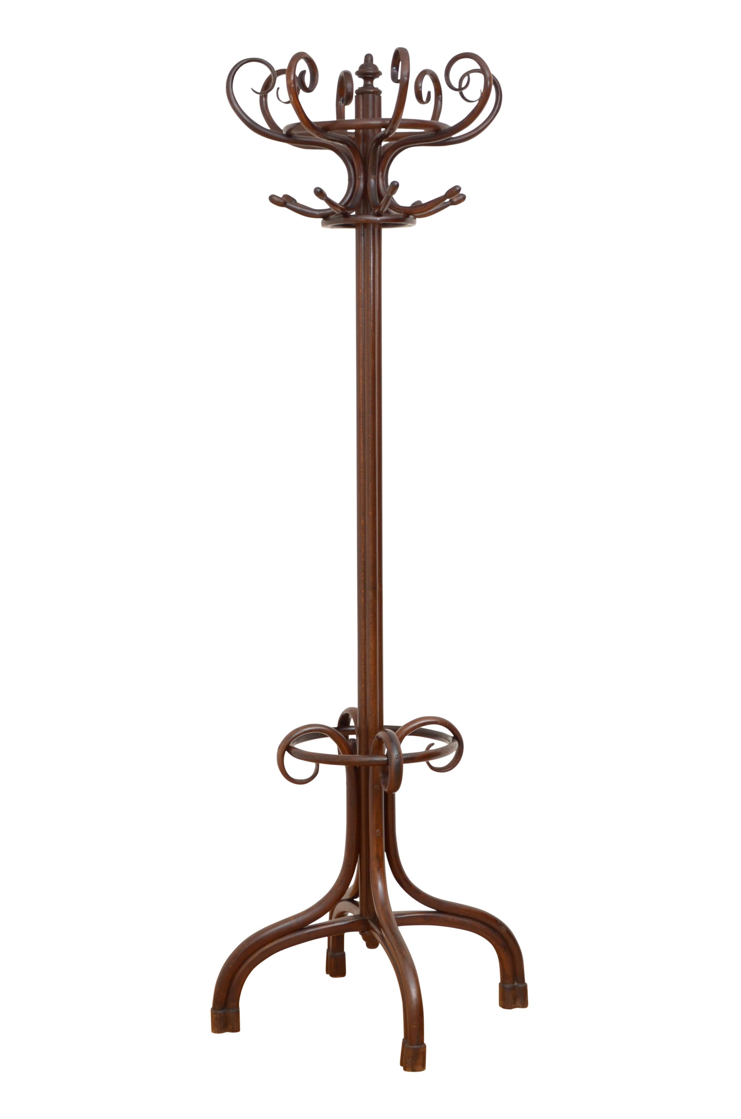 0232 Fine early 20th century bentwood hall stand, having 8 S shaped coat hooks and 8 bentwood scrolls for hats, surmounted by a turned finial, supported on cluster column terminating in 4 downswept legs with a ring for sticks and umbrellas. This