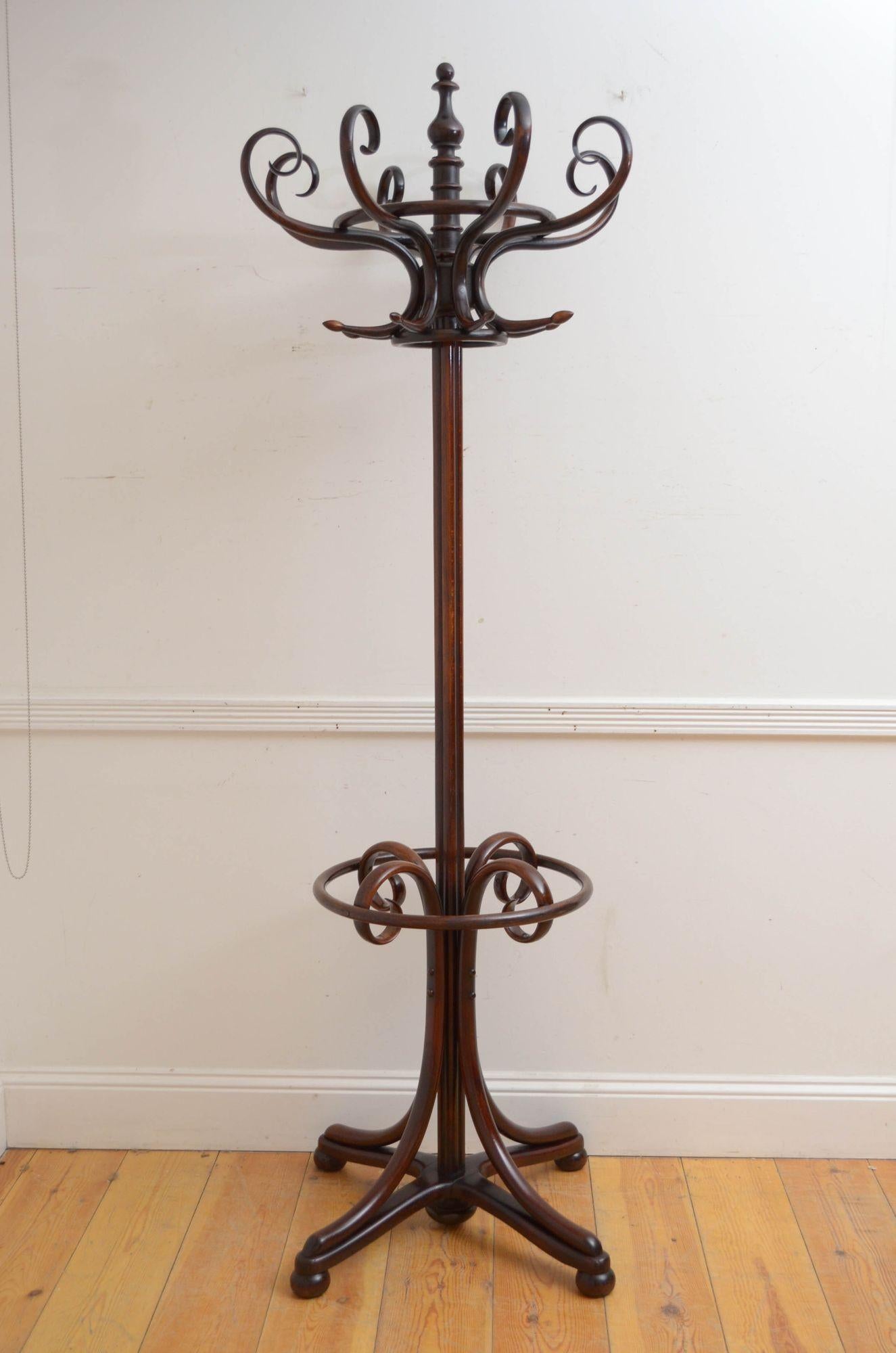 Sn5458 Elegant Thonet style bentwood hall stand, having revolving top with eight S shaped coat and hat hooks, surmounted by a turned finial, supported on cluster column terminating in four downswept legs with a ring for walking sticks and umbrellas.