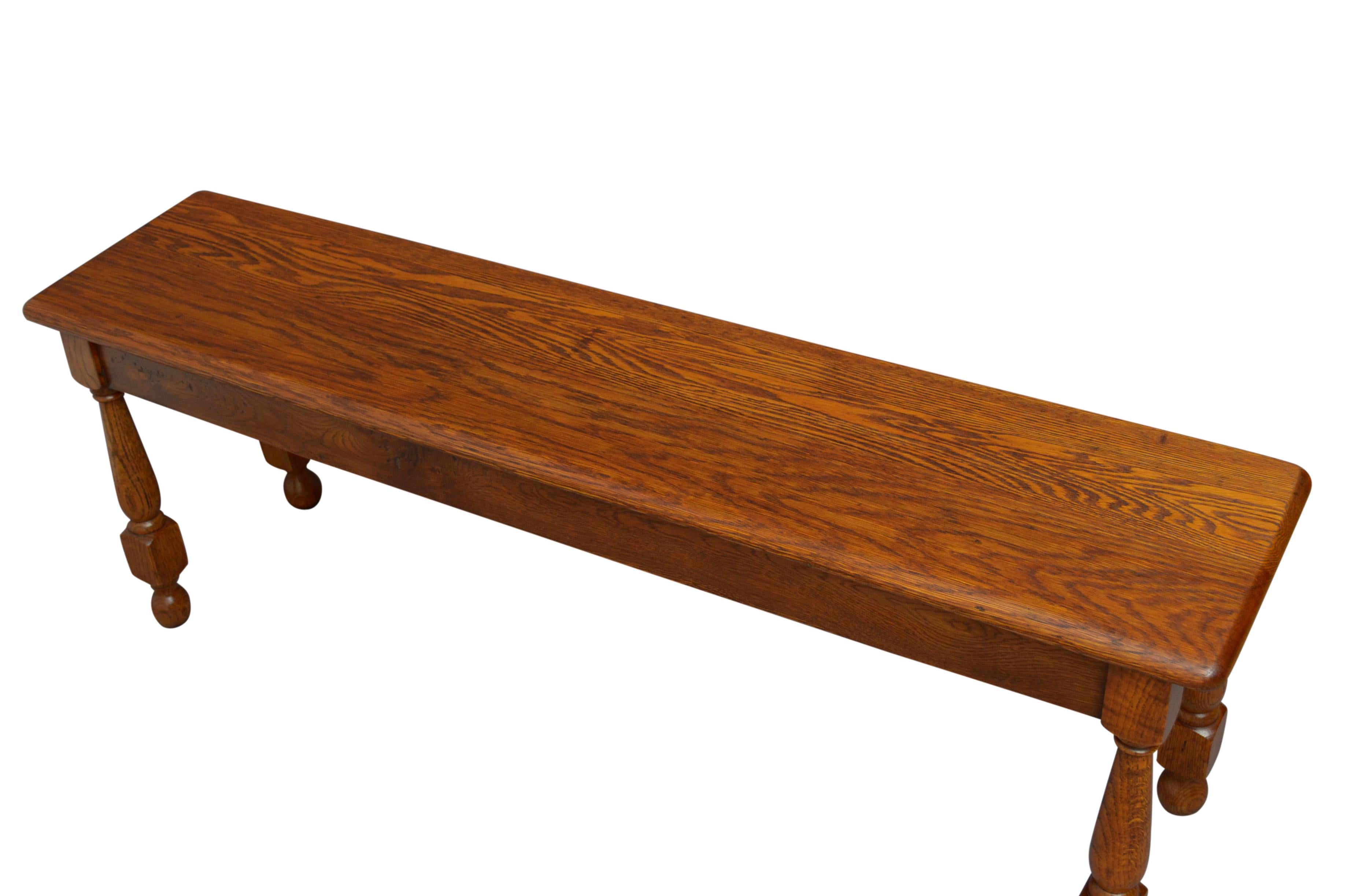 Simple solid oak hall seat with an attractive grain to the seat, standing on turned and tapered legs terminating in ball feet. This antique bench has been syamthetically restored and is in home ready condition. c1930.
Measures: H17