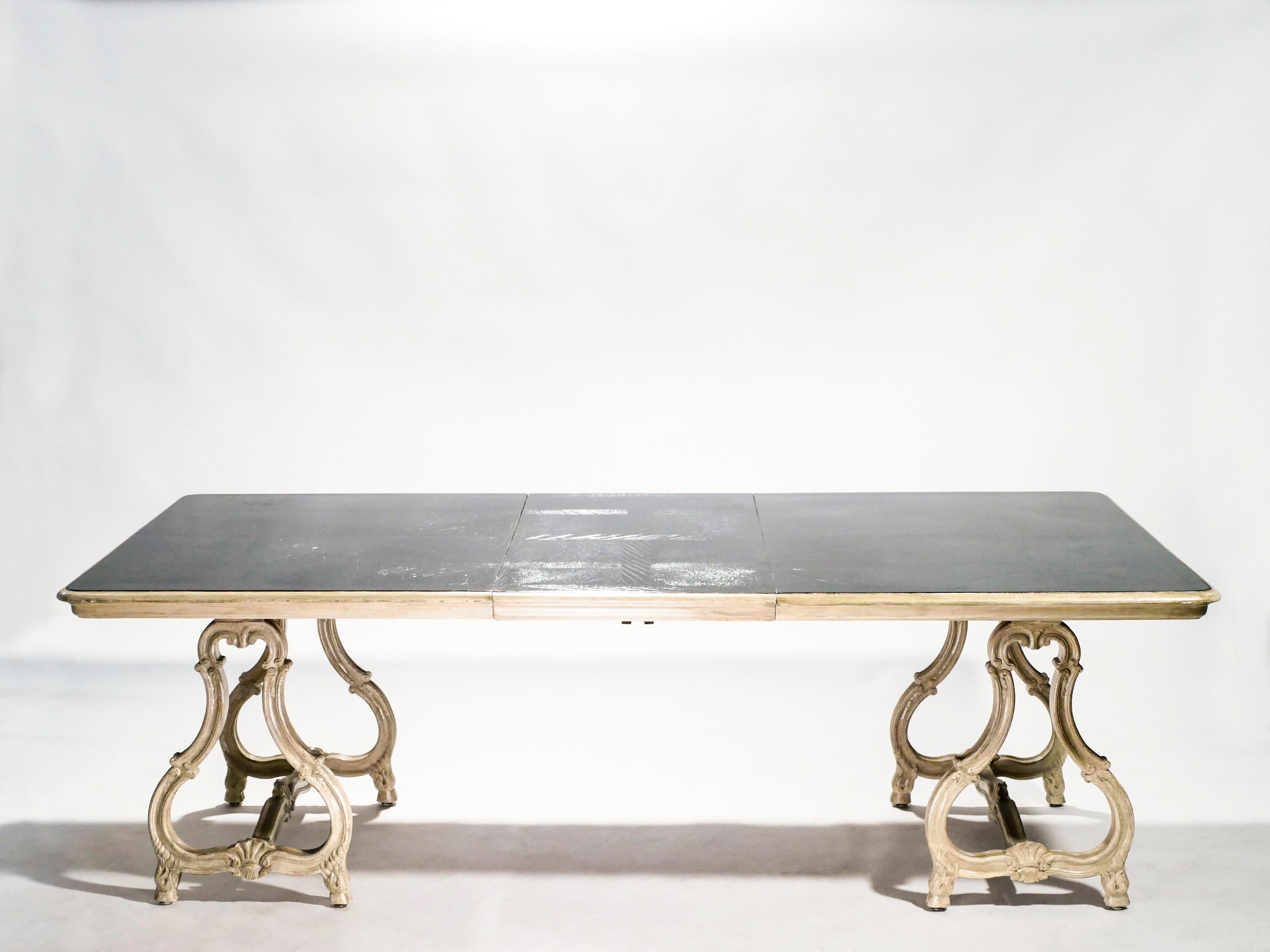 Unique dining table from the early days of Maison Jansen, in a pure Regence style, made of solid carved patinated mahogany.The beautiful painted structure has developed a stunning beige patina over time, revealing the careful craftsmanship at every