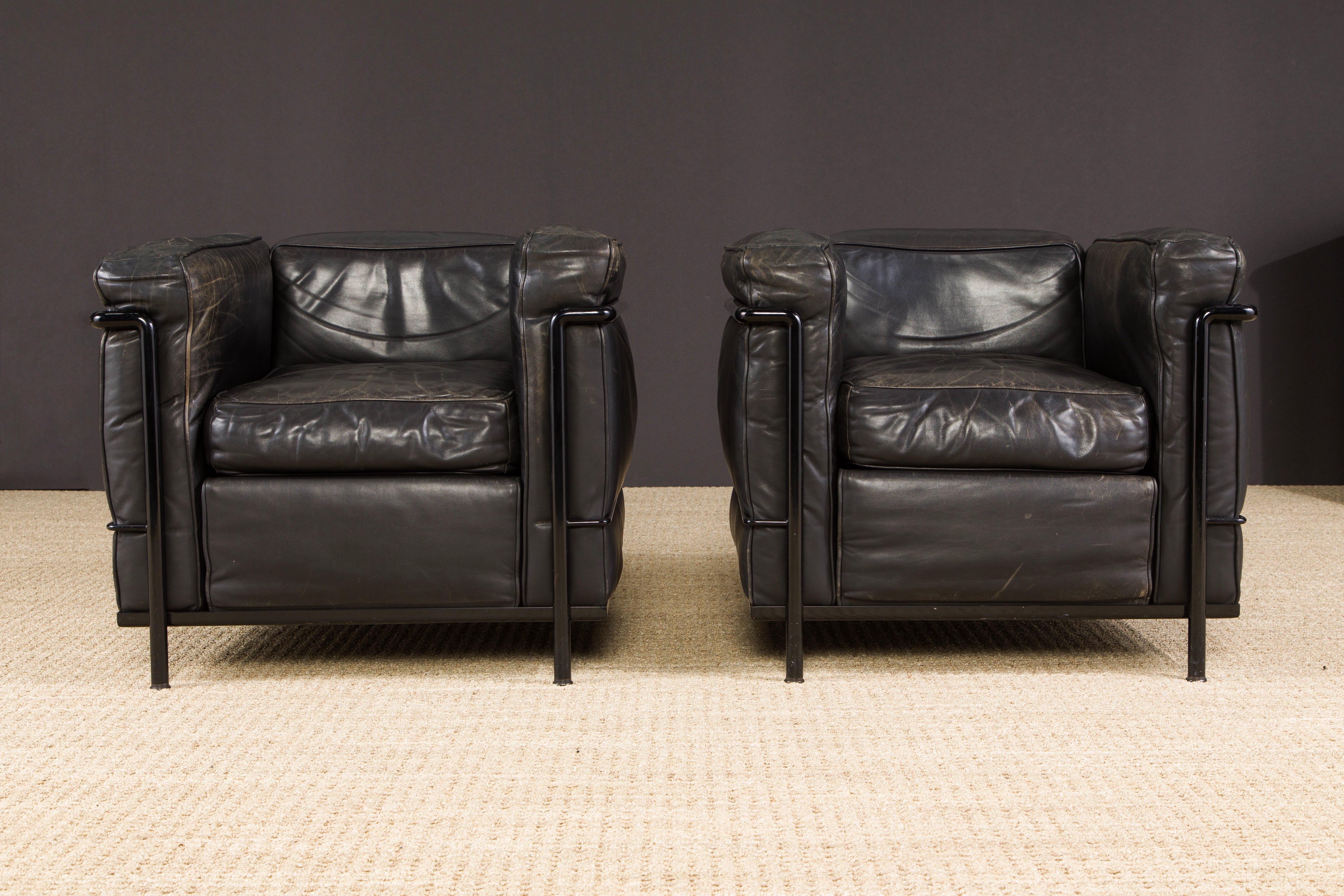 This incredibly comfortable pair of Le Corbusier for Cassina 'LC2' club chairs (authentic signed and earlier year production examples with low number production numbers stamped on both frames) in gorgeous thick Italian black leather on black frames