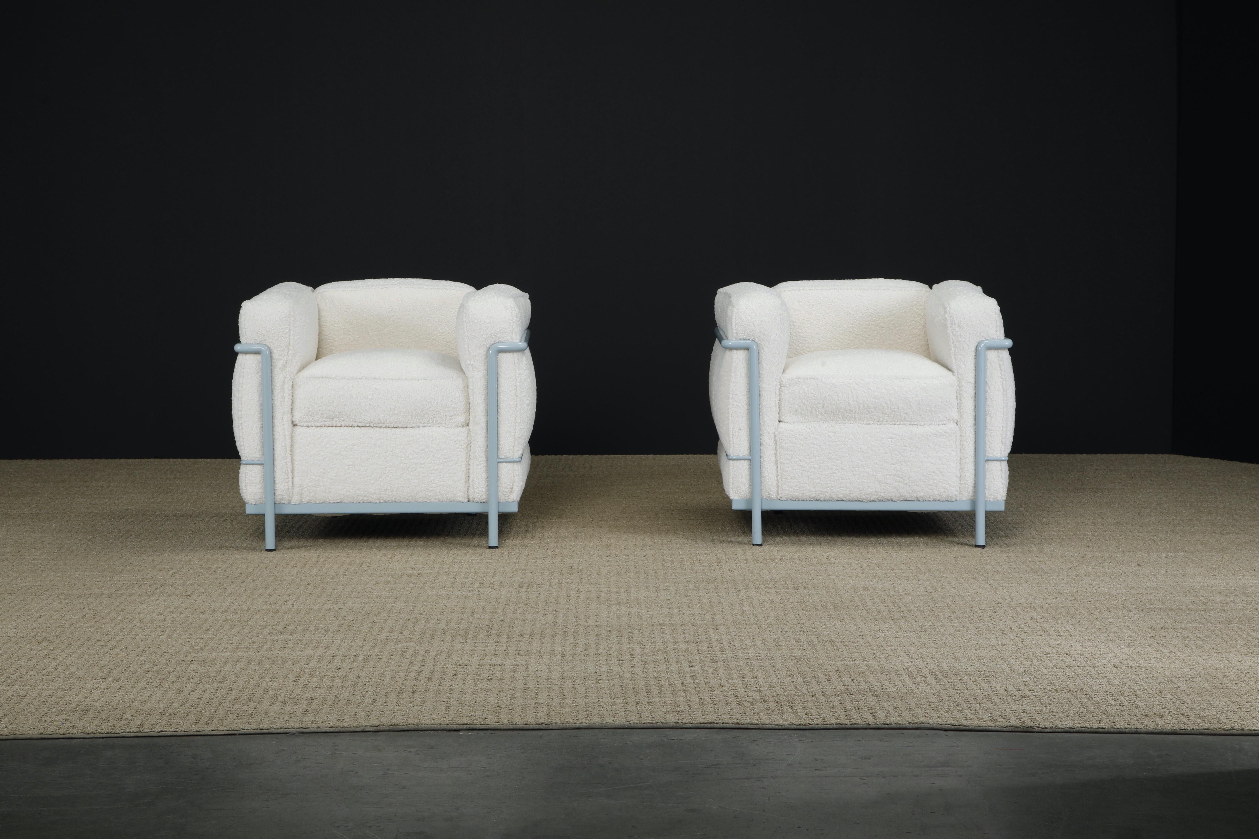 This incredibly comfortable pair of Le Corbusier for Cassina 'LC2' club chairs (authentic signed and earlier year production examples) in gorgeous newly reupholstered nubby white bouclé with original light blue frames are stamped underneath the arms