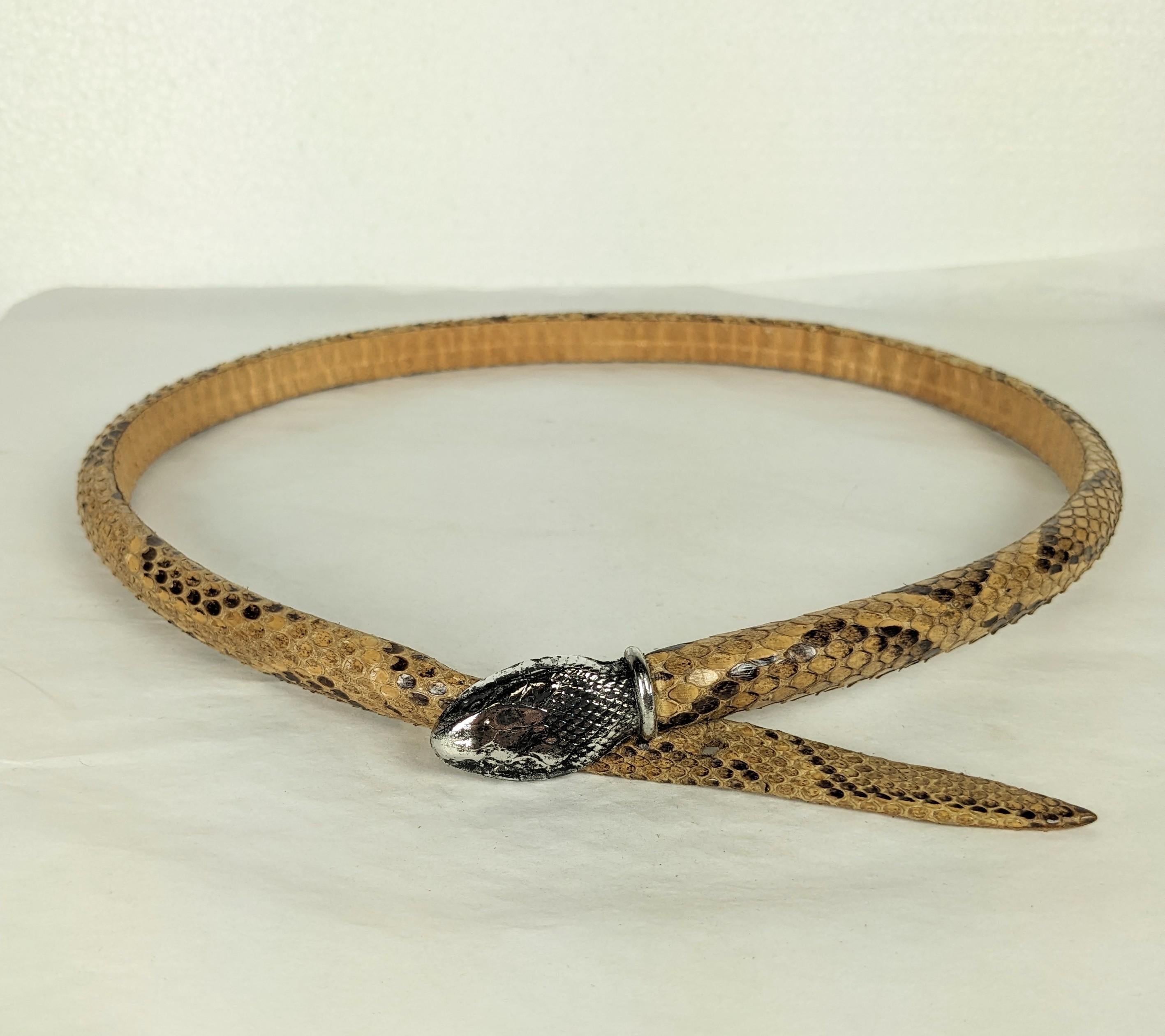 Rare Yves Saint Laurent Haute Couture snake skin belt from the 1970s. Padded to be 3 dimensional and set with a silvered bronze snake head which serves as the clasp. Unlabeled HC from an important collection of an artisanal Maison who worked for