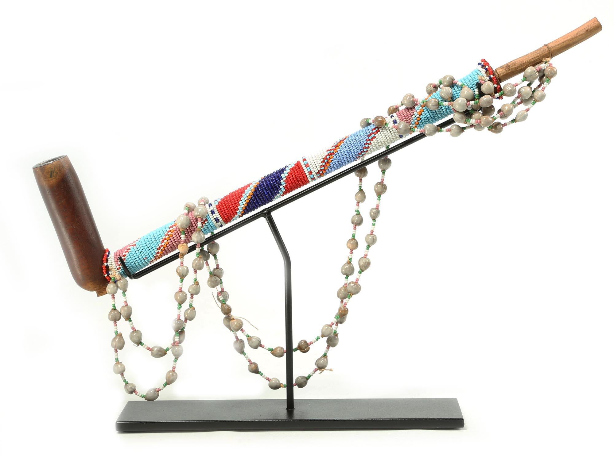Tribal Early Zulu Carved Wood Pipe with Beaded Stem and Strap on Stand South Africa For Sale