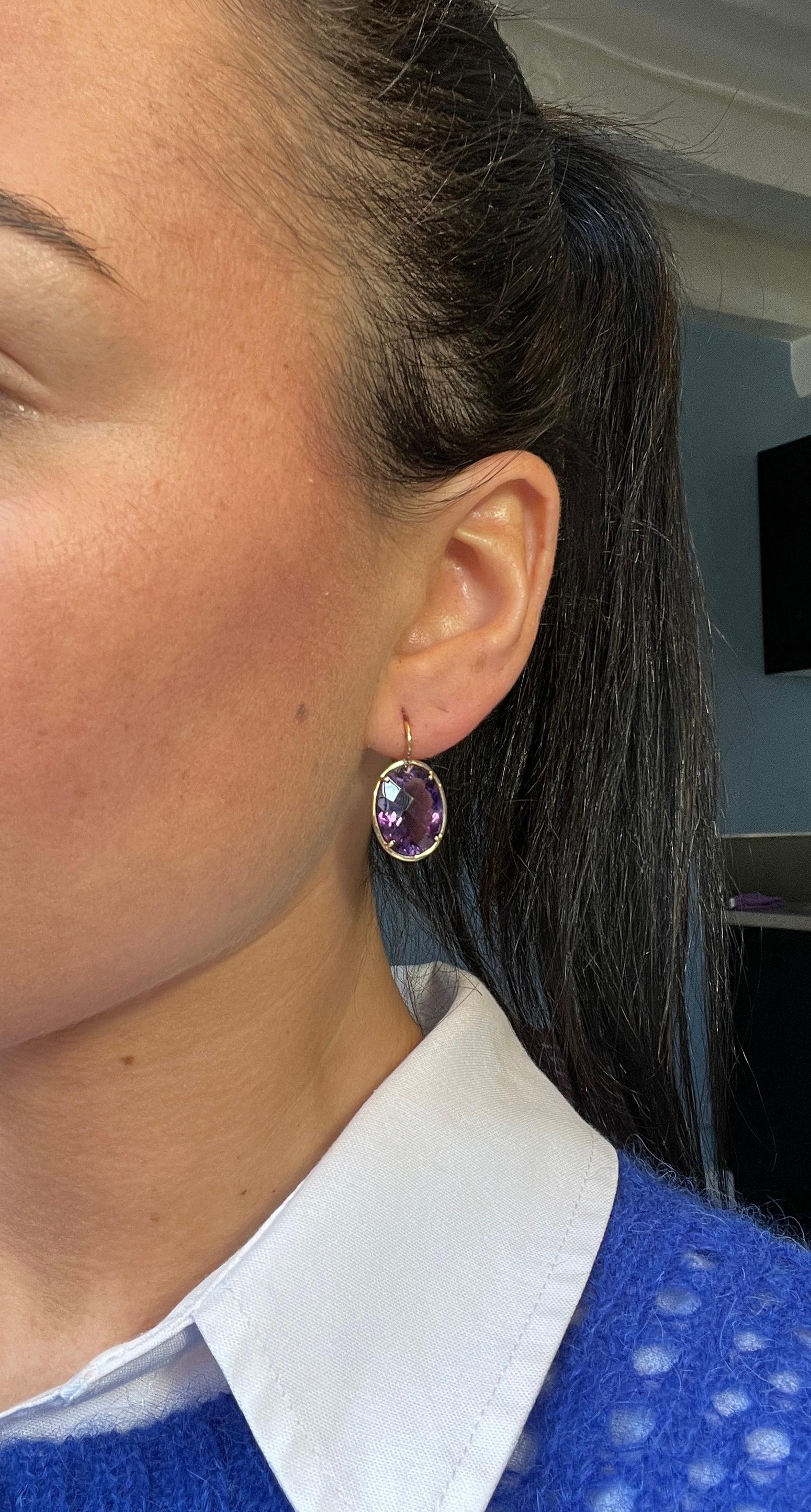 Earring Amethyst Yellow Gold 18 Carat

This pair of 18k yellow gold earrings features an oval-cut amethyst stone. The stone measures 1.7 cm x 1.4 cm or 0.6 inches/ 0.55 inches. This brightly colored stone weighs 15.5 carats. The amethyst is attached