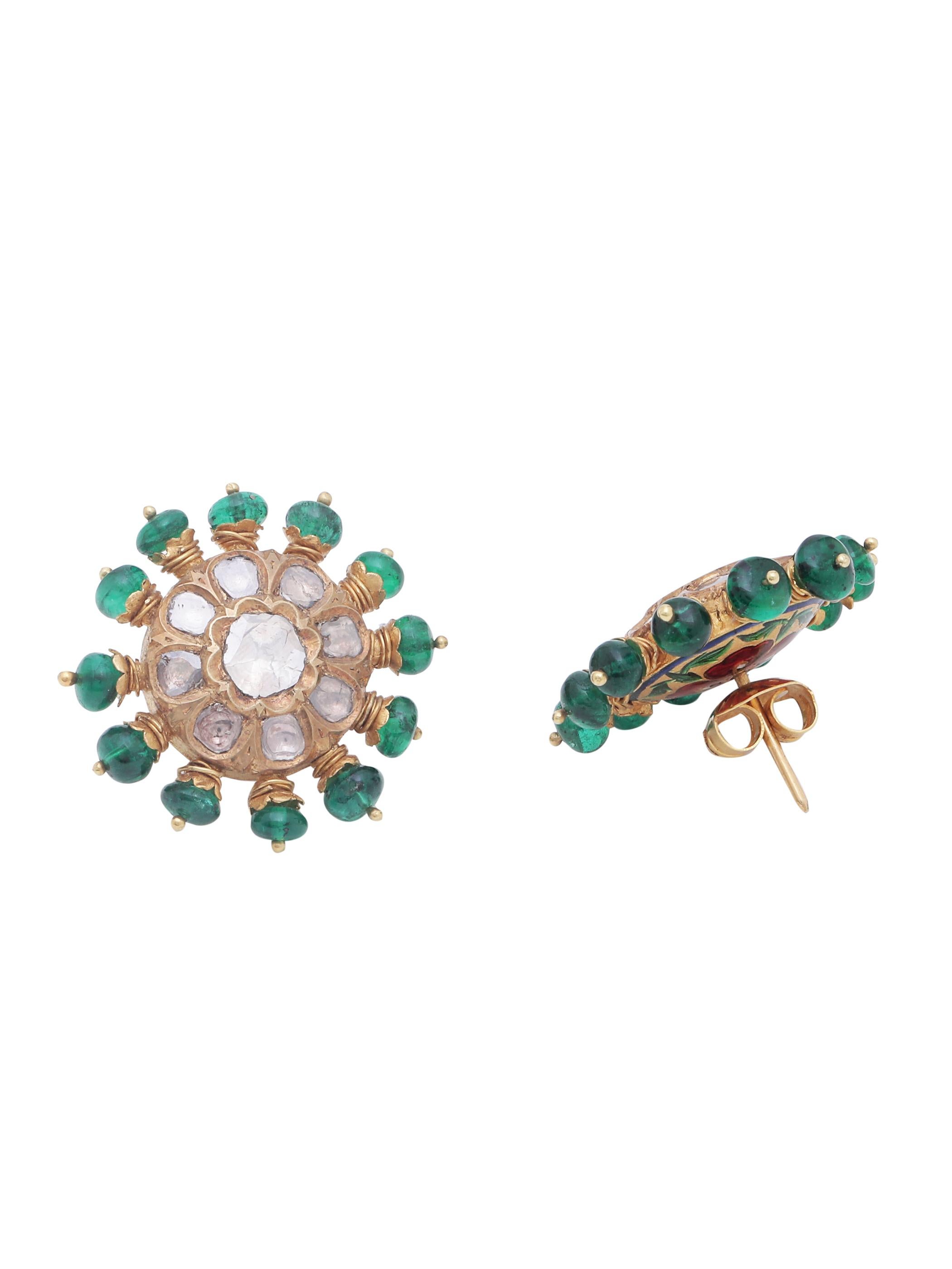 A pair of Studs with Beautiful Flat Rose cut diamonds and Emerald beads set all around. 
The Zambian Emerald beads are set in a very unique way on the circumference of the earring. The diamonds are set using 