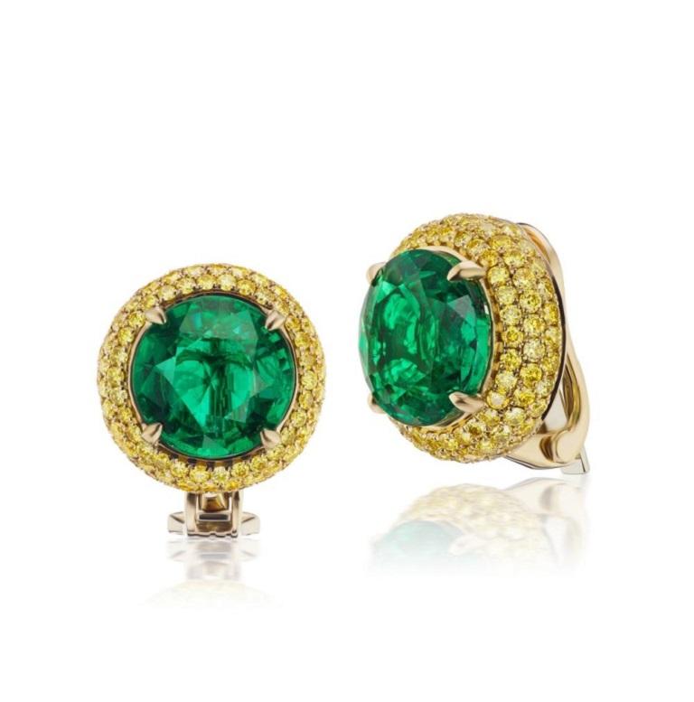 EARRING WITH EMERALD AND FANCY INTENSE YELLOW Rich yellow diamond halos surround an impressive Emerald center stone of approximately 4.75 cts. Each stone makes this a rare and unique color combination Item: # 02719 Metal: 18k Y Lab: Gia Color
