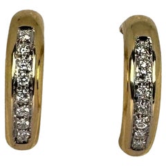 Boucles d
oreilles or jaune 14 carats taille brillant 16 diamants pureté si 0.64 carat