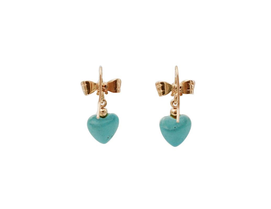 Lovely earrings in 18k yellow gold structure, with a golden ribbon in the upper part and a heart pendant made of turquoise paste in the lower part.
The origin of these earrings goes back to the 1990s, they were totally handmade by Italian master