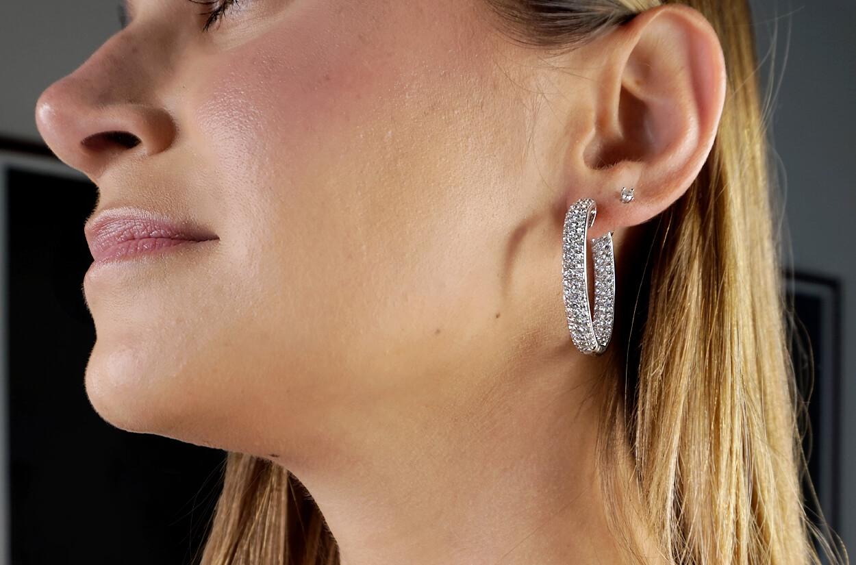 These hoop earrings are a symphony of luxury and sophistication. Impeccably crafted from 18kt white gold, they exude timeless allure. Adorning each hoop are 6.31 carats of natural top-quality diamonds, scintillating like a starlit night. These