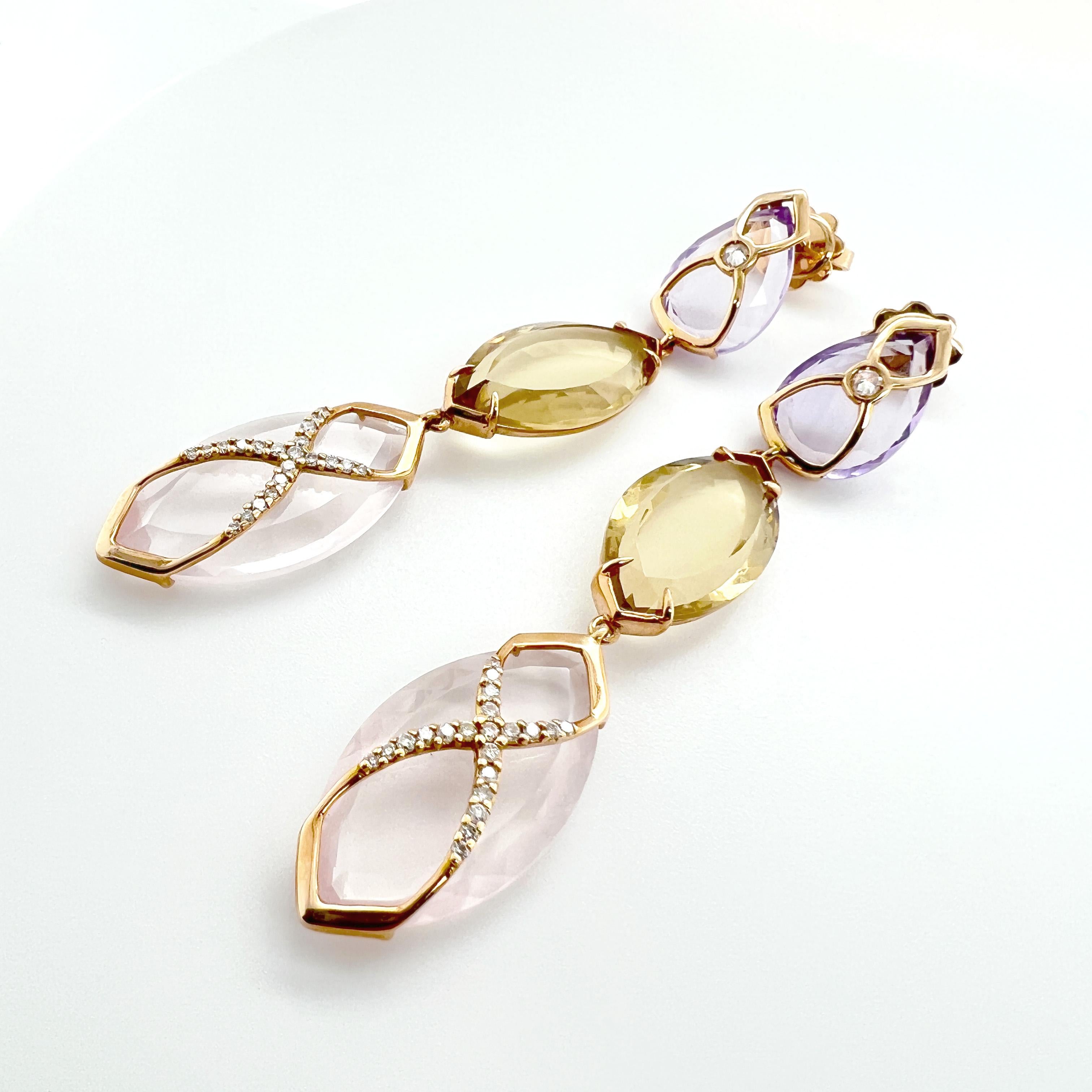 These earrings are a beautiful combination of 18KT gold, diamonds, and colorful gemstones. The design features a drop-shaped amethyst gemstone, a navette-cut lemon quartz, and a navette-cut pink quartz, all delicately arranged in a stunning