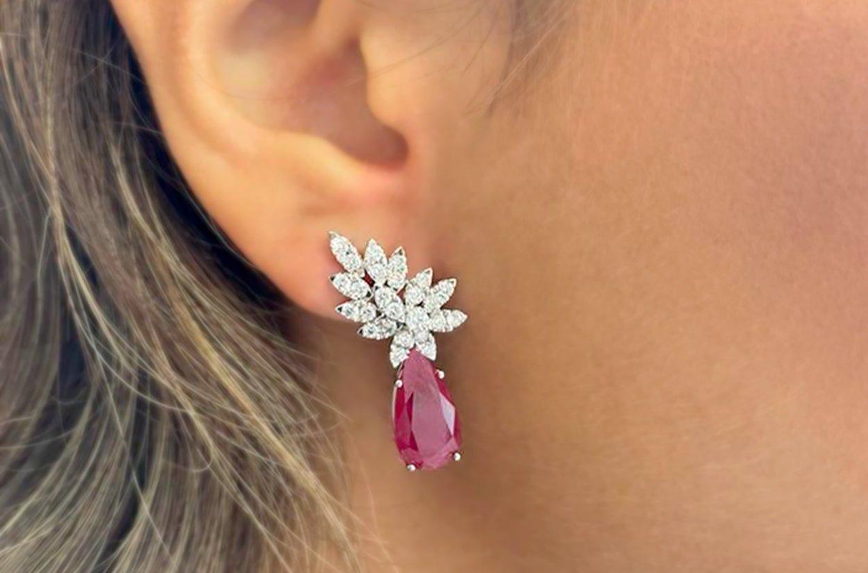 Earrings 18kt White Gold with 2 Pear Rubies 7.20 carats and 59 Natural Brilliant Cut Diamonds 1.35 carats Statement Drops.

Our earrings are specifically designed to dazzle your friends and surprise your loved ones. The sparkling and brilliant
