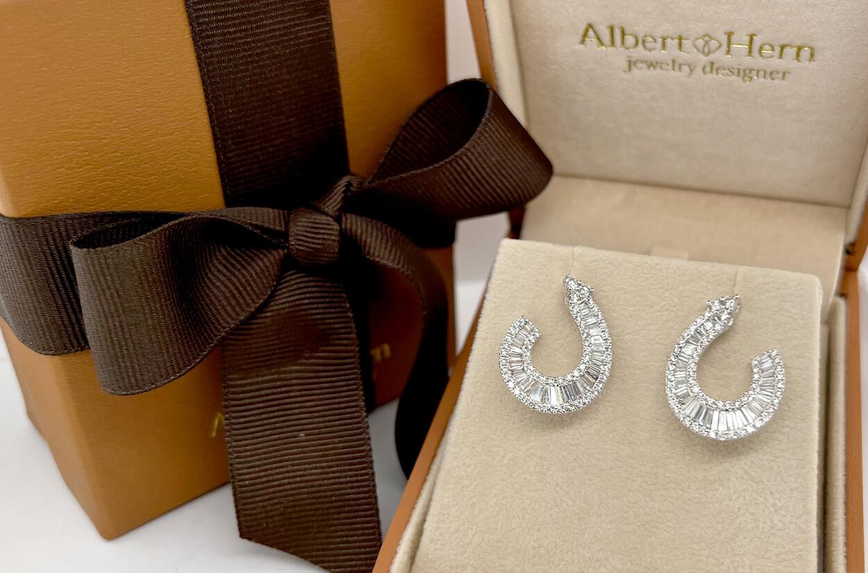 Gracefully crafted from lustrous 18kt white gold, these exquisite open tear earrings are a symphony of elegance and sophistication. The intricate design features a harmonious blend of round and baguette diamonds, each meticulously placed to create a