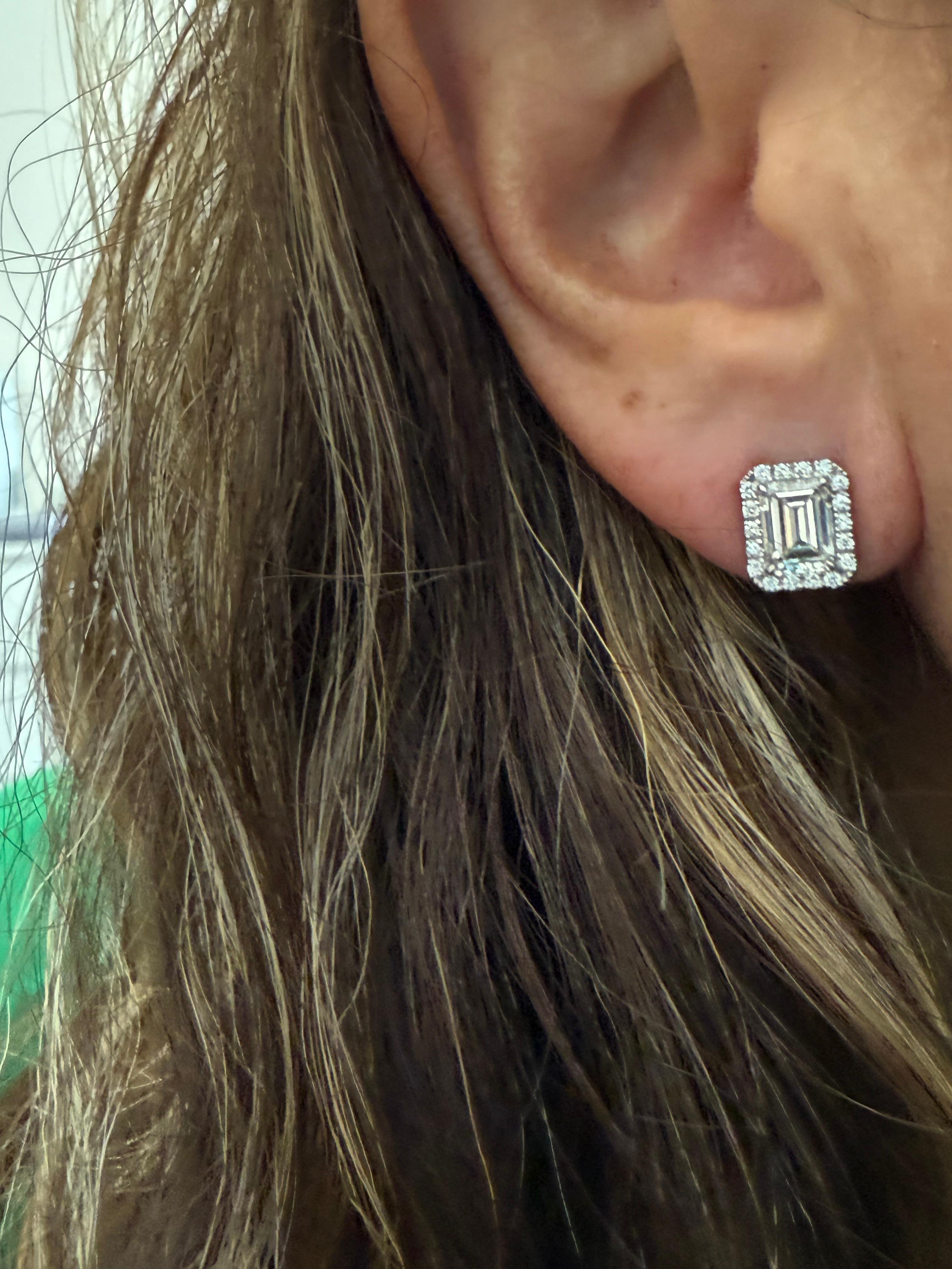 These exquisite earrings are crafted in 18kt white gold, showcasing a stunning combination of brilliance and sophistication. At the heart of each earring is an emerald-cut diamond, meticulously chosen for its exceptional clarity and captivating