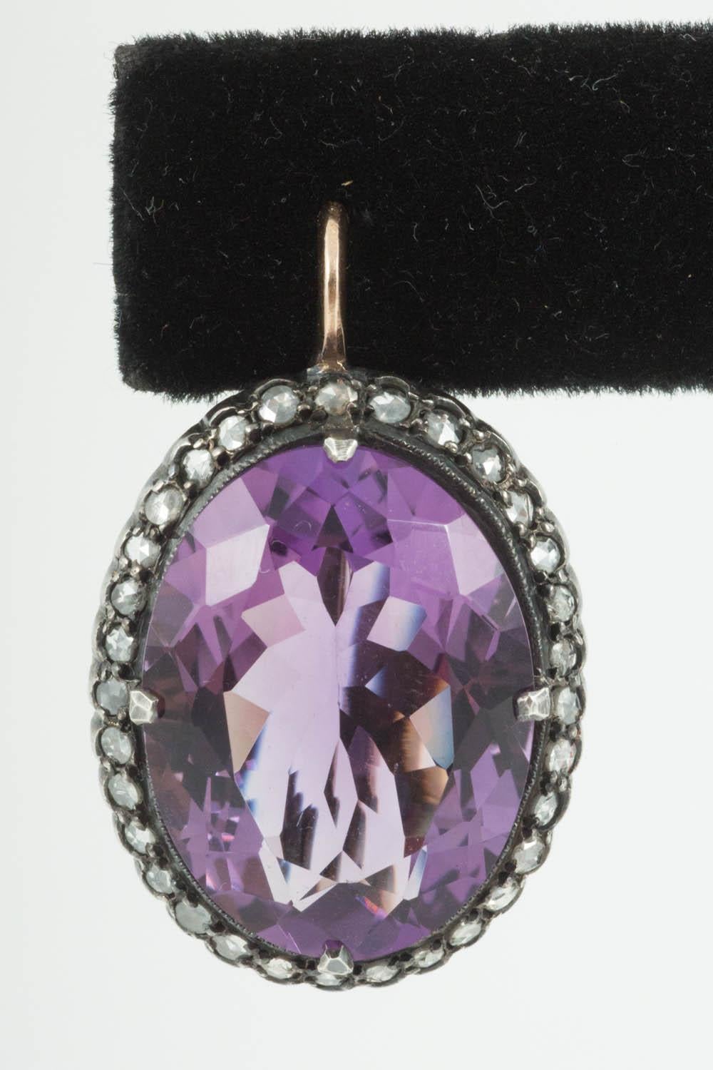 A pair of large oval Amethyst earrings of bright,siberian colour,with a surround of rose cut diamonds,mounted in silver and gold.Russian 56 mark stamped on the original ear fittings.Circa 1890