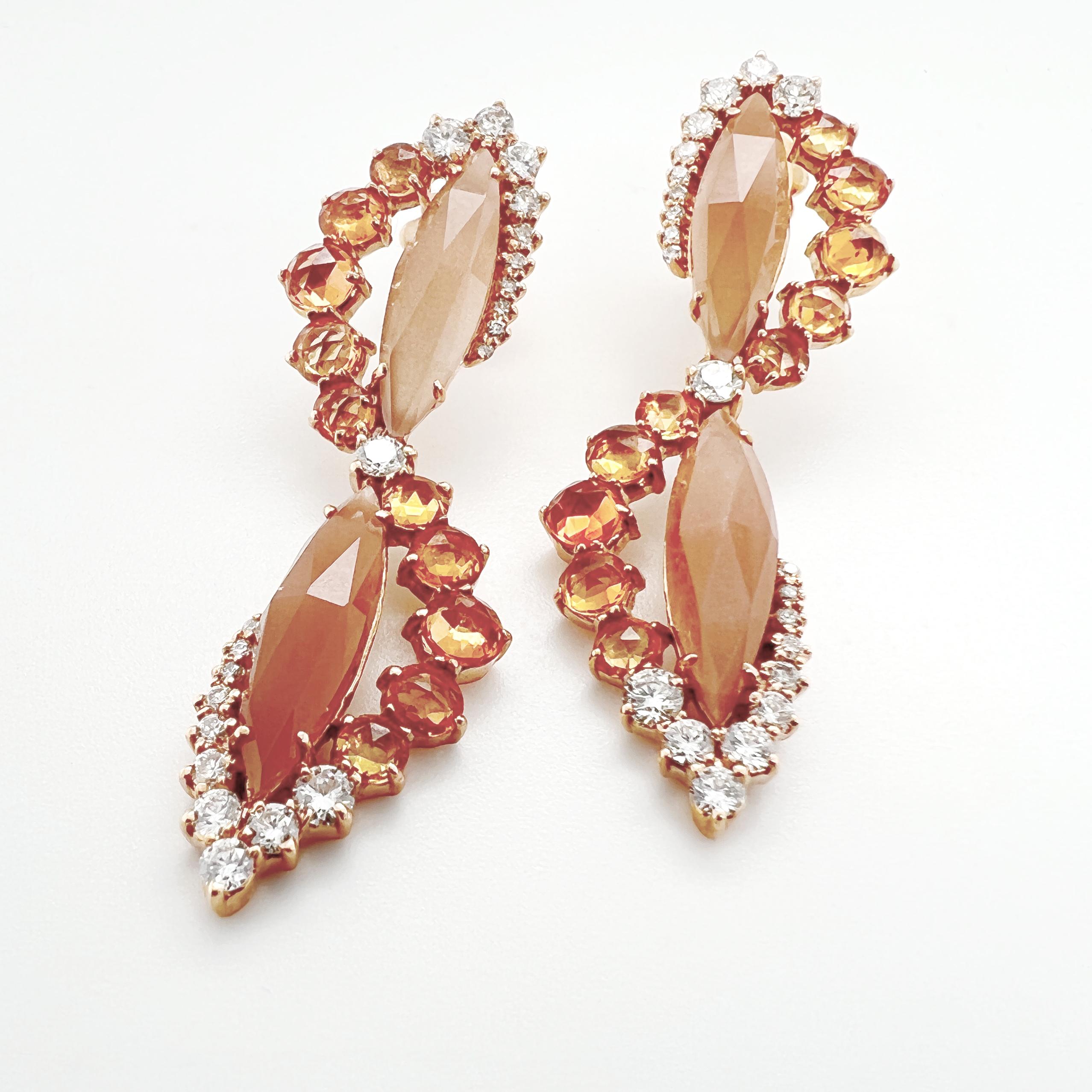These earrings are crafted in 18kt pink gold and feature a stunning combination of orange moonstone, orange sapphires, and natural diamonds. The orange moonstone has a captivating and mysterious quality, with a shimmering play of orange and pink