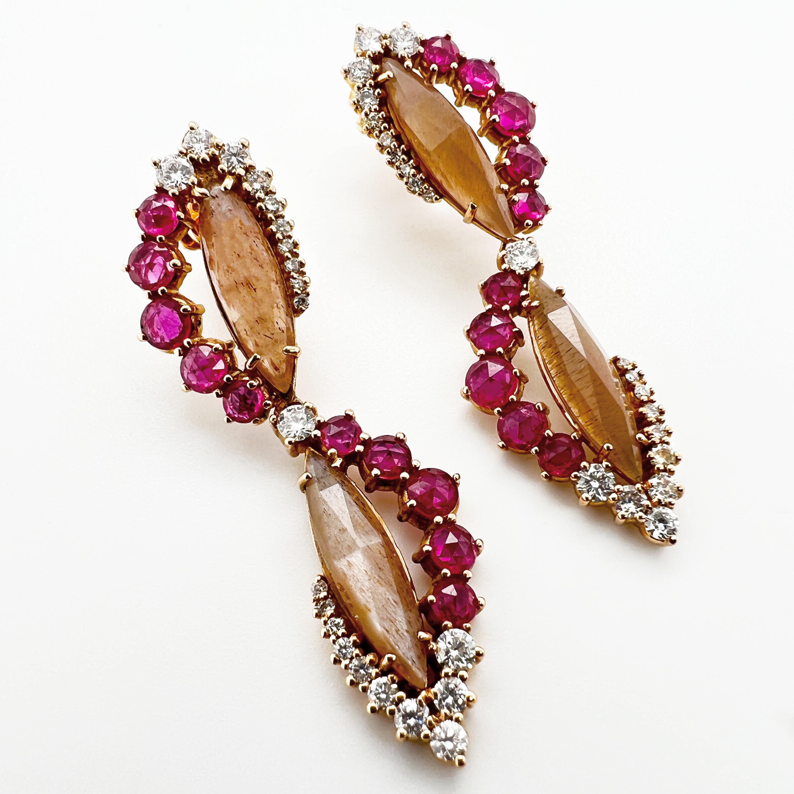 These earrings are crafted in 18kt pink gold and feature an elegant combination of brown moonstone, rubies and natural diamonds. The brown moonstone has a unique and iridescent quality, reflecting different hues of brown and orange in the light. The