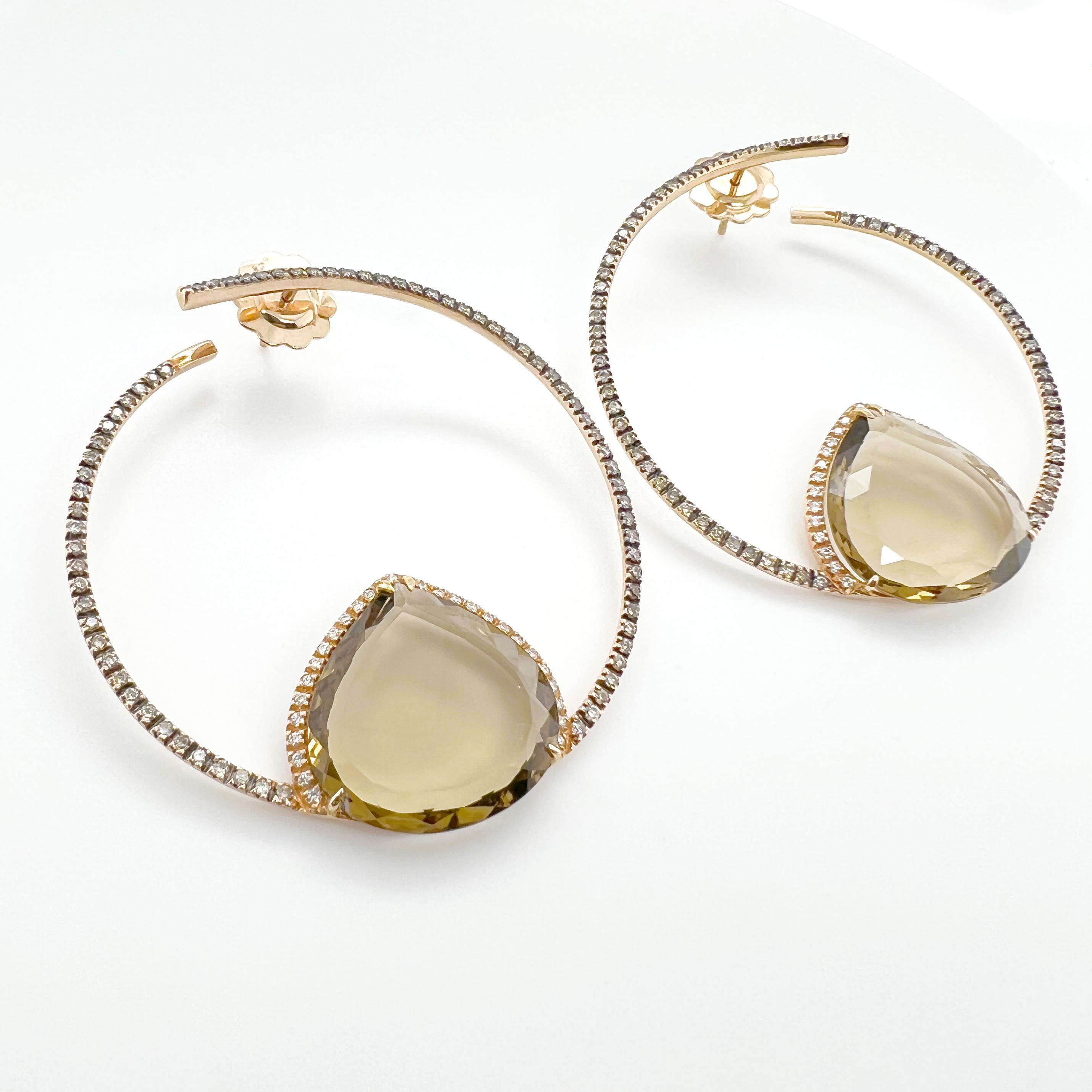 These frontal hoop earrings are a stunning design, crafted with 18kt pink gold and featuring brown and white natural diamonds and smoky quartz. The hoop design creates a dynamic and wearable accessory that adds a touch of sophistication and elegance