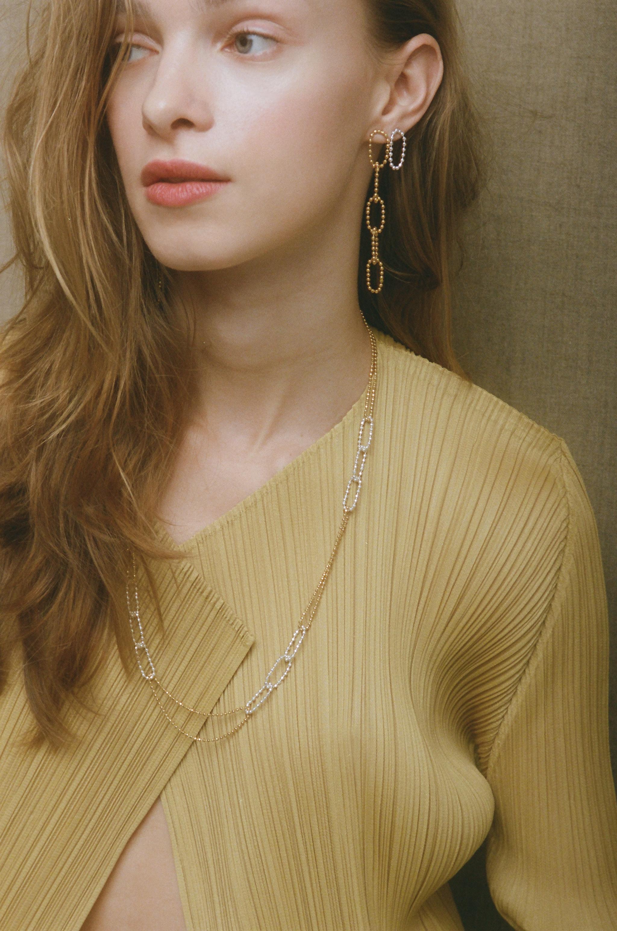 Honeycomb long earrings 

Gold plated, lightweight link earrings made of a delicate sterling silver beaded chain. The chain adds movement to the look and reflects light to make your face glow up. 

All of our earrings have 10 K posts to avoid