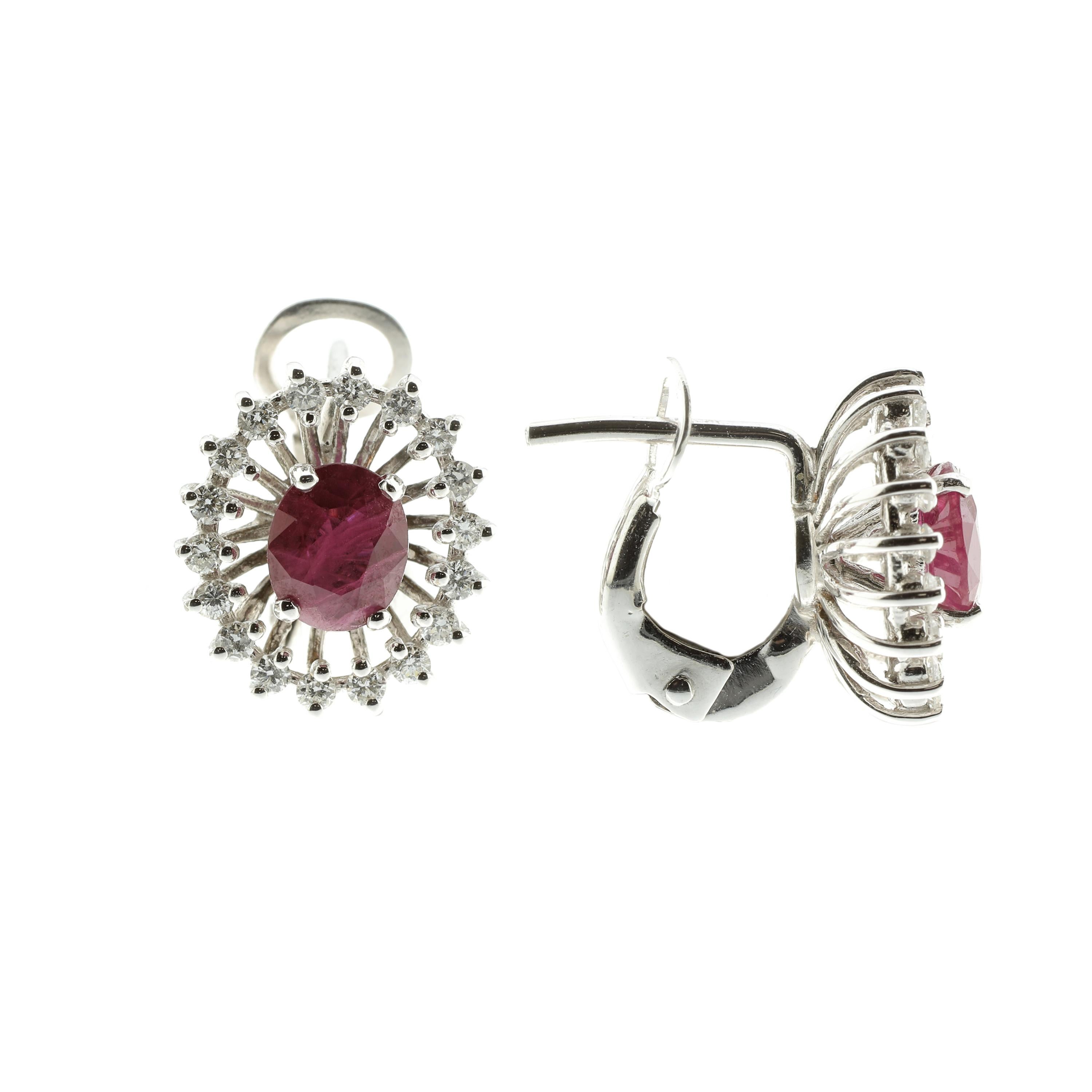 These earrings are masterfully created entirely by hand from 18-karat white gold with white diamonds, rated G VS, and rubies. They are a showcase piece of jewellery: the rubies total 1.5 carats and the design emphasizes their incredible vibrancy and