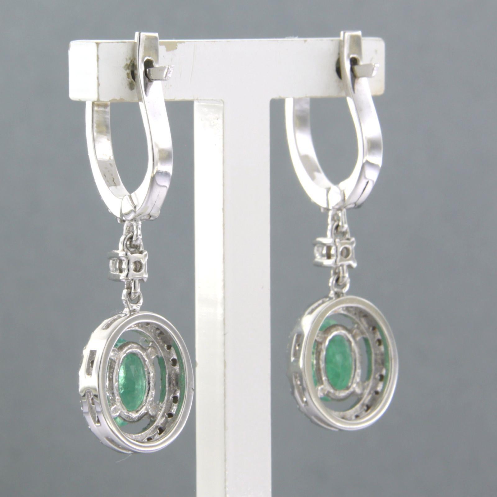Women's Earrings set with emerald and diamonds 14k white gold For Sale