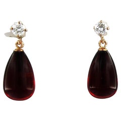 Earrings set with garnet and diamonds 18k pink gold
