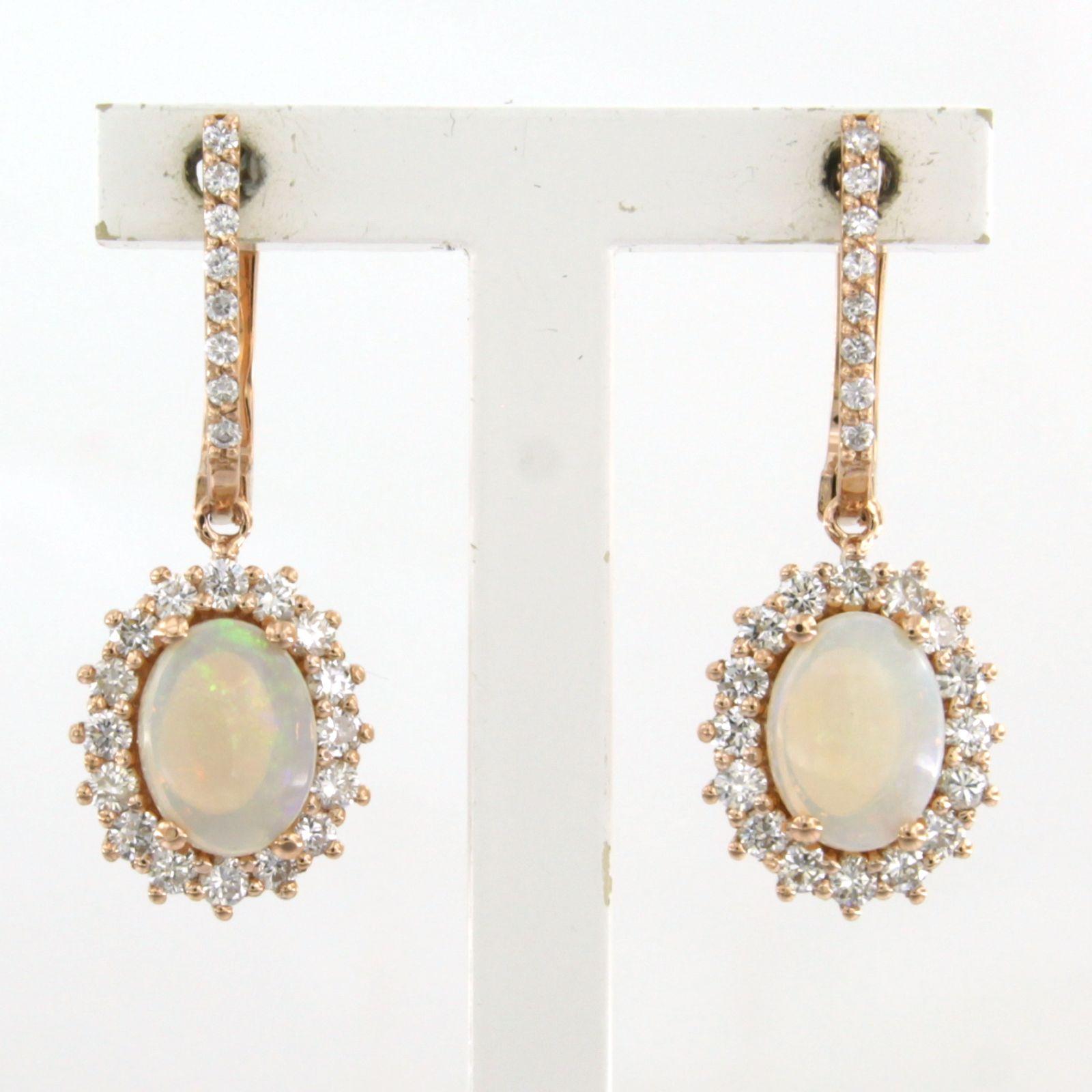 18k rose gold entourage earrings set with opal and brilliant cut diamonds up to 0.75ct - F/G – VS/SI

Detailed description:

the size of the earring is 2.7 cm long by 1.0 cm wide

Total weight 5.6 grams

set with

- 2 x 7.0 mm x 5.0 mm oval cabachon