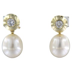Earrings set with pearl and brilliant cut diamond up to 0.30ct. 14k yellow gold