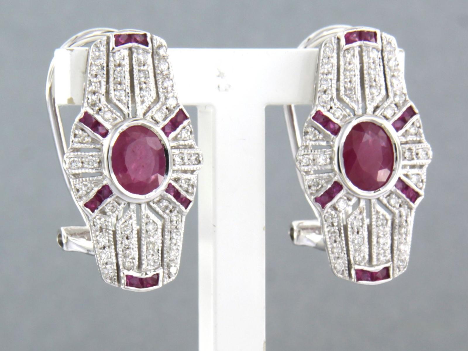 14k white gold ear clips set with sapphire and single cut diamond 0.34 ct - F/G - VS/SI

detailed description

the top of the ear clip is 2.1 cm long by 1.2 cm wide

weight 6.7 grams

set with

- 2 x 5.0 mm - 5.8 mm oval facet cut heated ruby, total