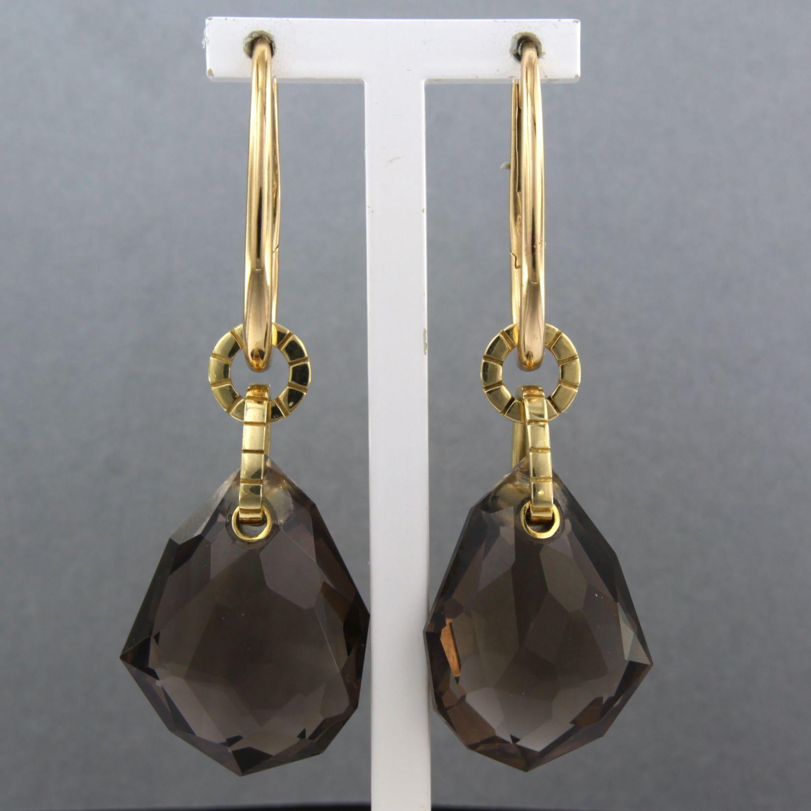 18k yellow gold earrings set with smoky quartz - size 5.5 cm x 2.0 cm

detailed description:

the size of the earring is 5.5 cm long by 2.0 cm wide

weight: 22.7 grams

set with :

- 2 x 2.6 cm x 2.0 cm drop shape facet cut smoky quartz

color: