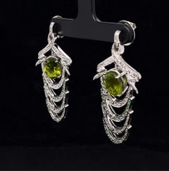 Orecchini Spinosa in oro bianco 18k con diamanti e peridoti