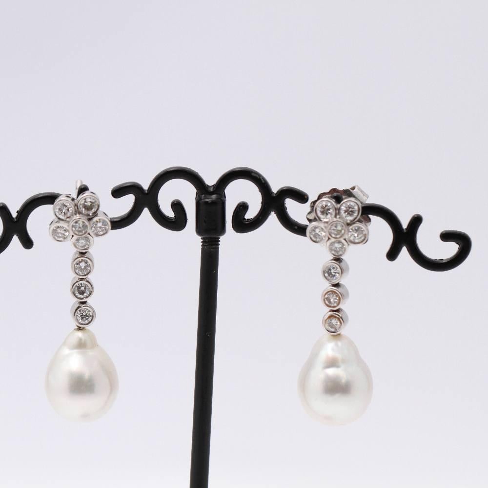 Women's White Gold Earrings  18x Brilliant Cut Diamonds weighing approx. 1.62 cts. in G/Vs quality  2x 11mm Australian Natural Pearls  Extra Pressure Clasp, fits perfectly in the ear  18kt White Gold  12.17 grams  Earrings size: 3,3cm long.  These