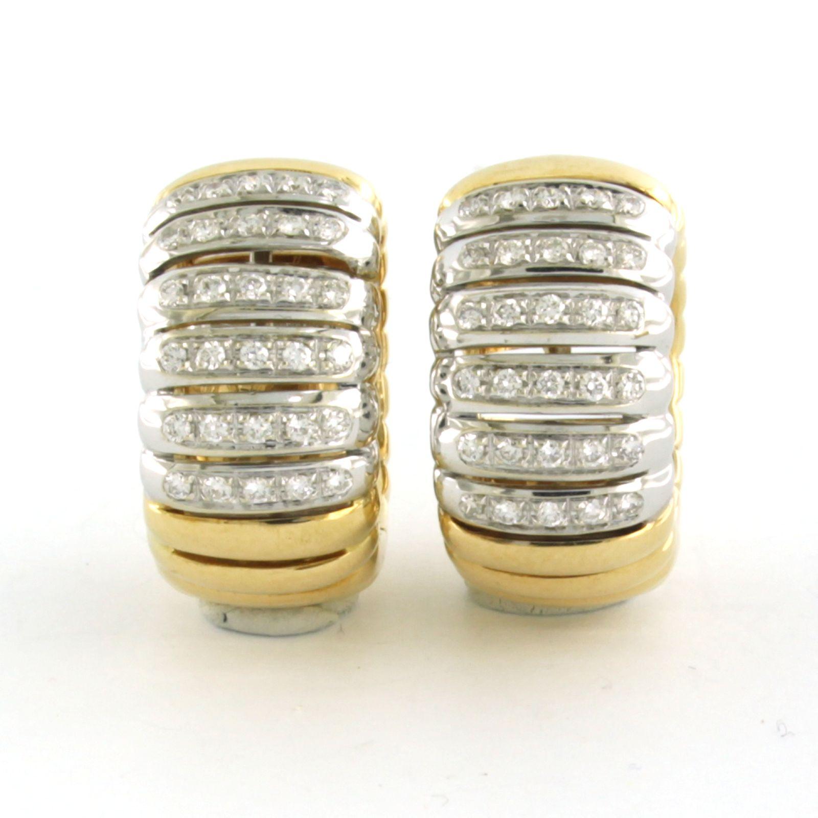 18k bicolor gold hoop earrings set with brilliant-cut diamonds up to 0.60 ct - F/G - VS/SI

Detailed description:

The top of the earring is 2.1 cm long and 1.1 cm wide.

Weight: 20.4 grams

Set with:

- 60 x 1.3 mm brilliant-cut diamonds, totaling