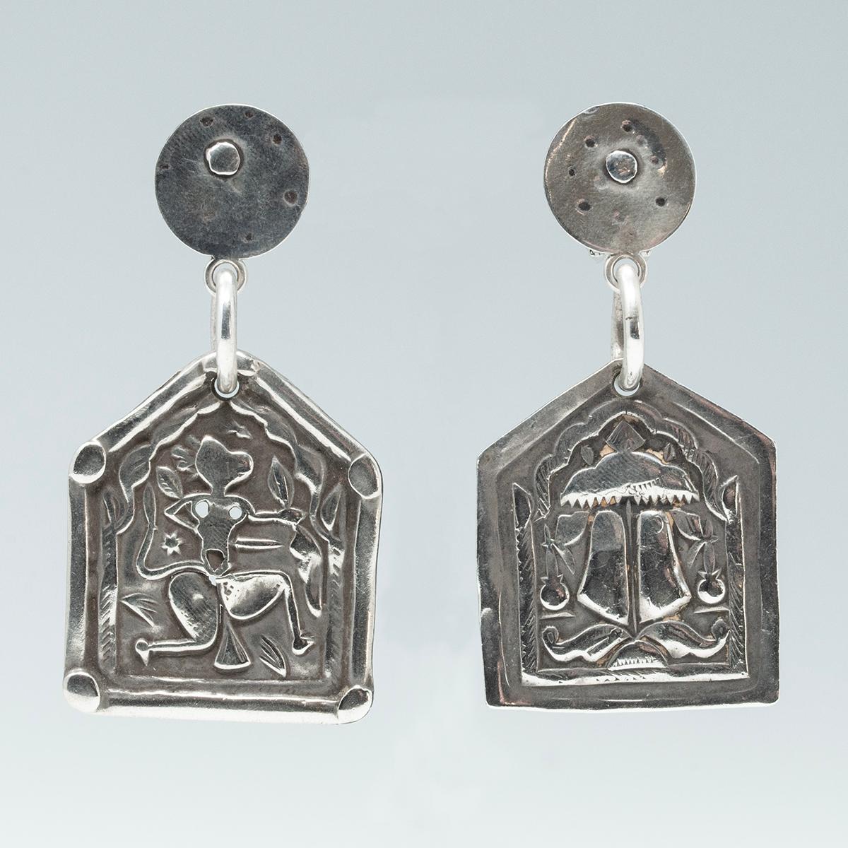  Earrings with Early 20th Century Silver Charms from India by Jewels of Santa Fe/Marrakesh

A wonderful pair of earrings made by Jewels with large silver pentagon-shaped charms from India anchored by her iconic hand-hammered silver discs. One amulet