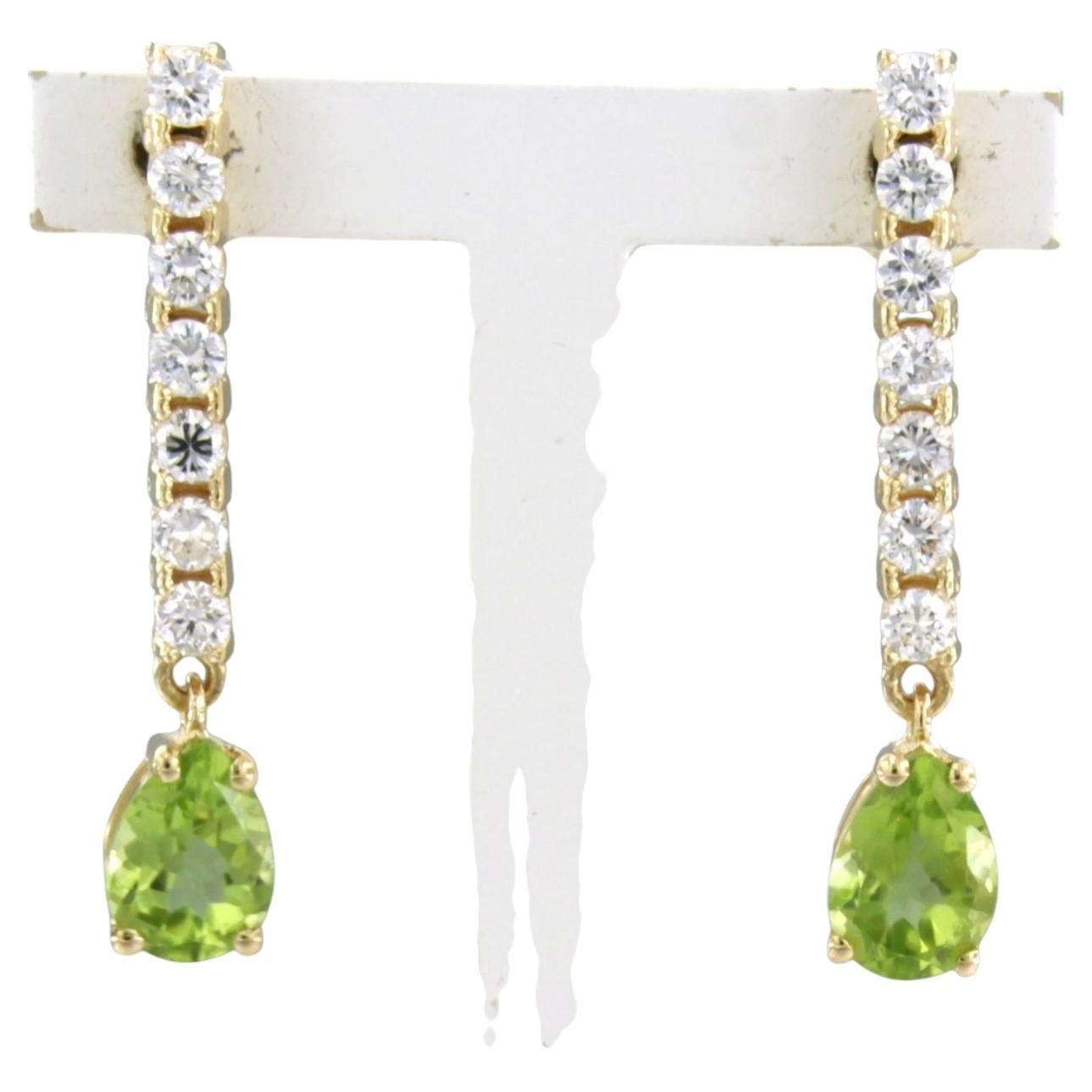 Earrings with peridot and brilliant cut diamonds up to 0.58ct 18k gold