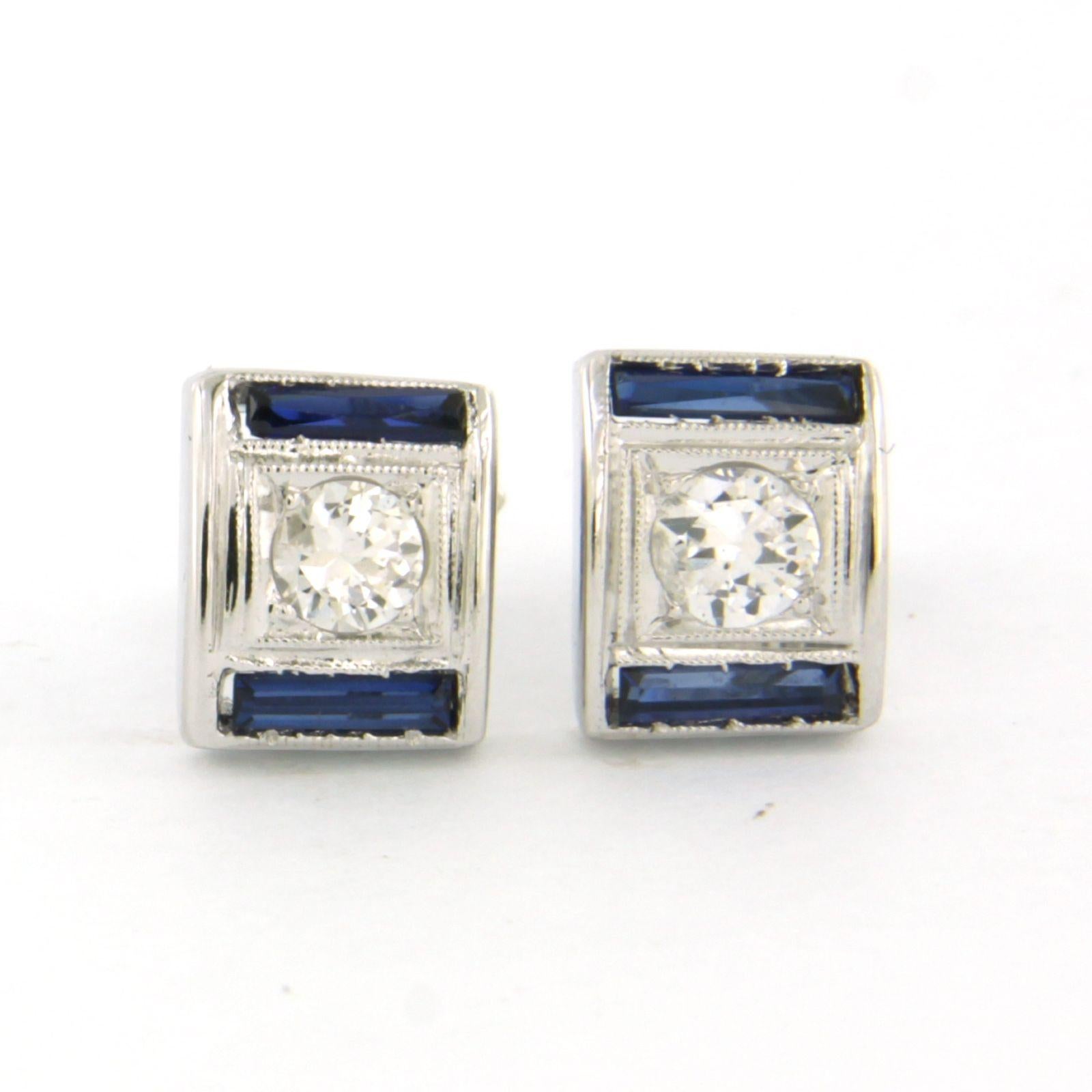 14k white gold earrings set with sapphire and brilliant cut diamonds. approximately 0.20 ct - F/G - SI

detailed description:

the size of the earring is 9.0 mm high and 7.3 mm wide

Total weight 3.0 grams

set with

- 4 x 5.0 mm x 1.0 mm taper cut