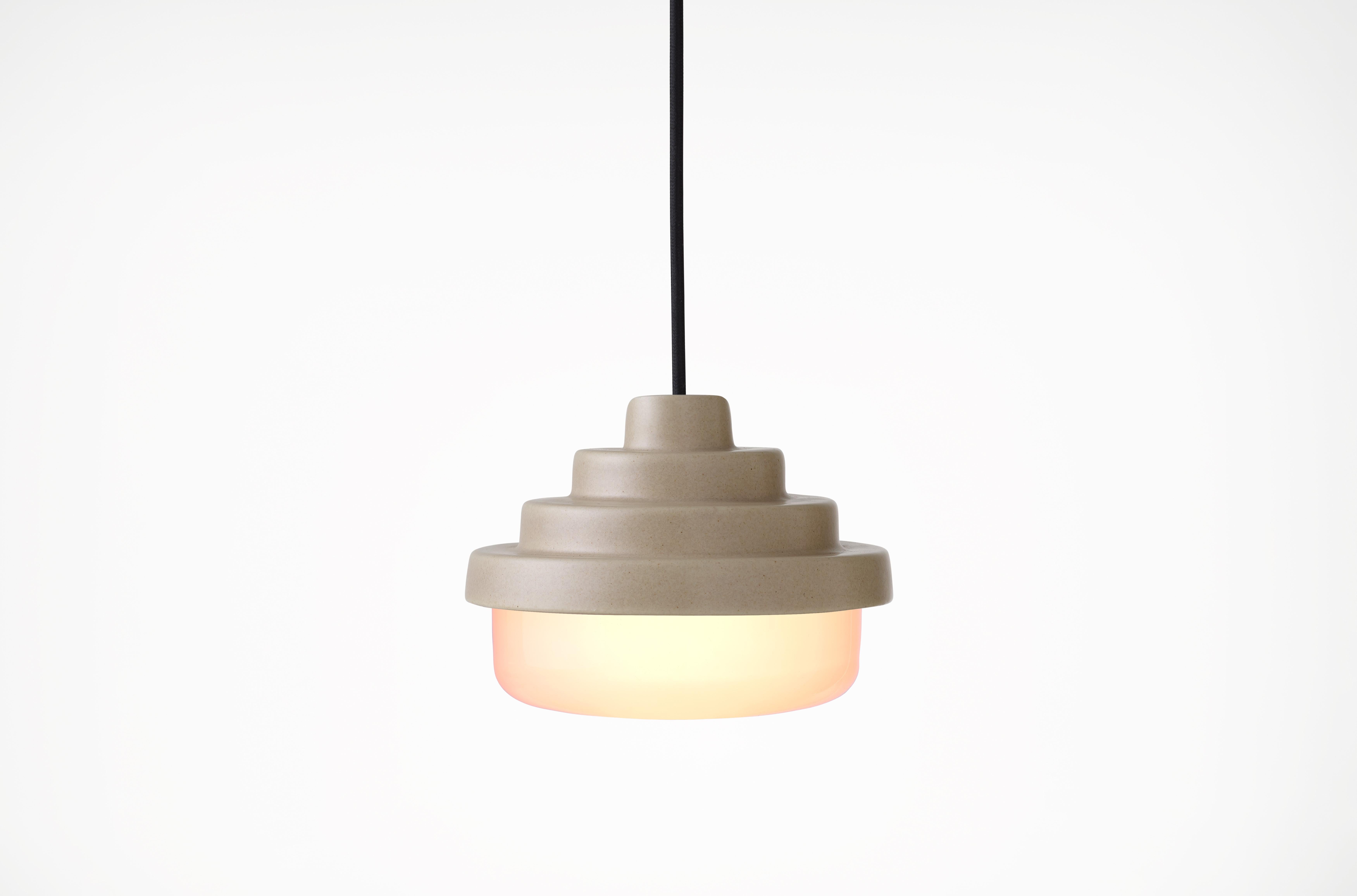 Earth and White Honey Pendant Light by Coco Flip
Dimensions: D 18 x W 18 x H 13 cm
Materials: Slip cast ceramic stoneware with blown glass. 
Weight: Approx. 2kg
Glass finishes: White.
Ceramic finishes: Earth satin glaze. 

Standard fixtures