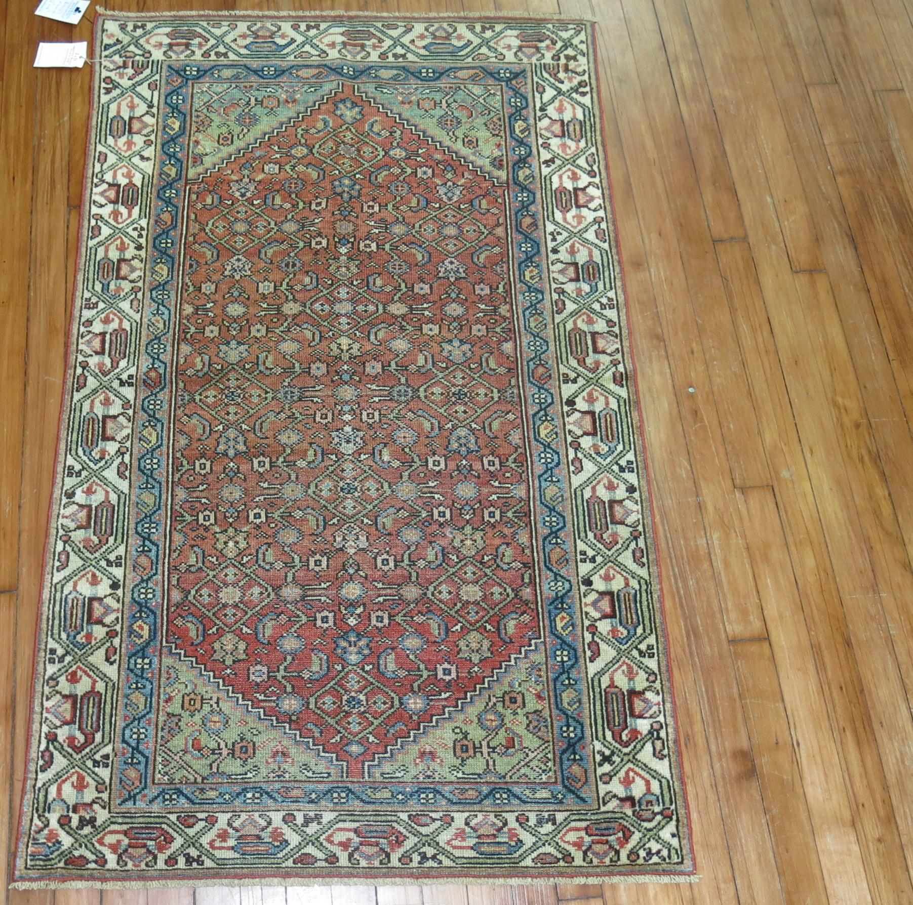One of a kind Persian Malayer throw size rug with a classic 4 corner herati design motif on a rust colored ground, accents in green, blue and ivory,

circa 1920, measures: 2'11