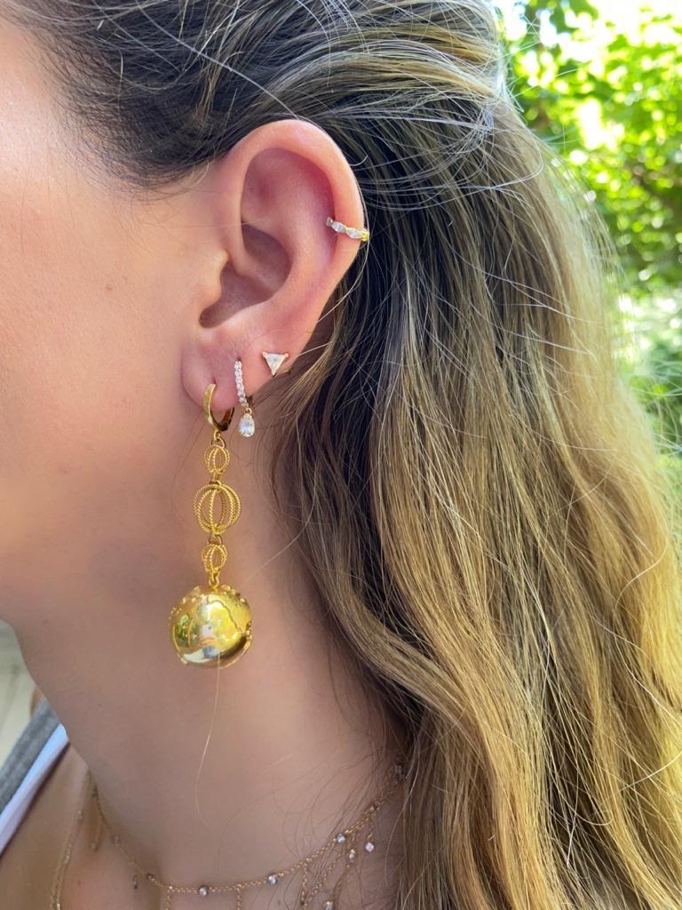 The Earth earrings are designed by Christina Alexiou.

The Earth earrings are crafted with 18k yellow gold and handmade in Greece.
The Earth is hollow, thus this pair of earrings is an easy to wear everyday piece of jewelry. This piece features the